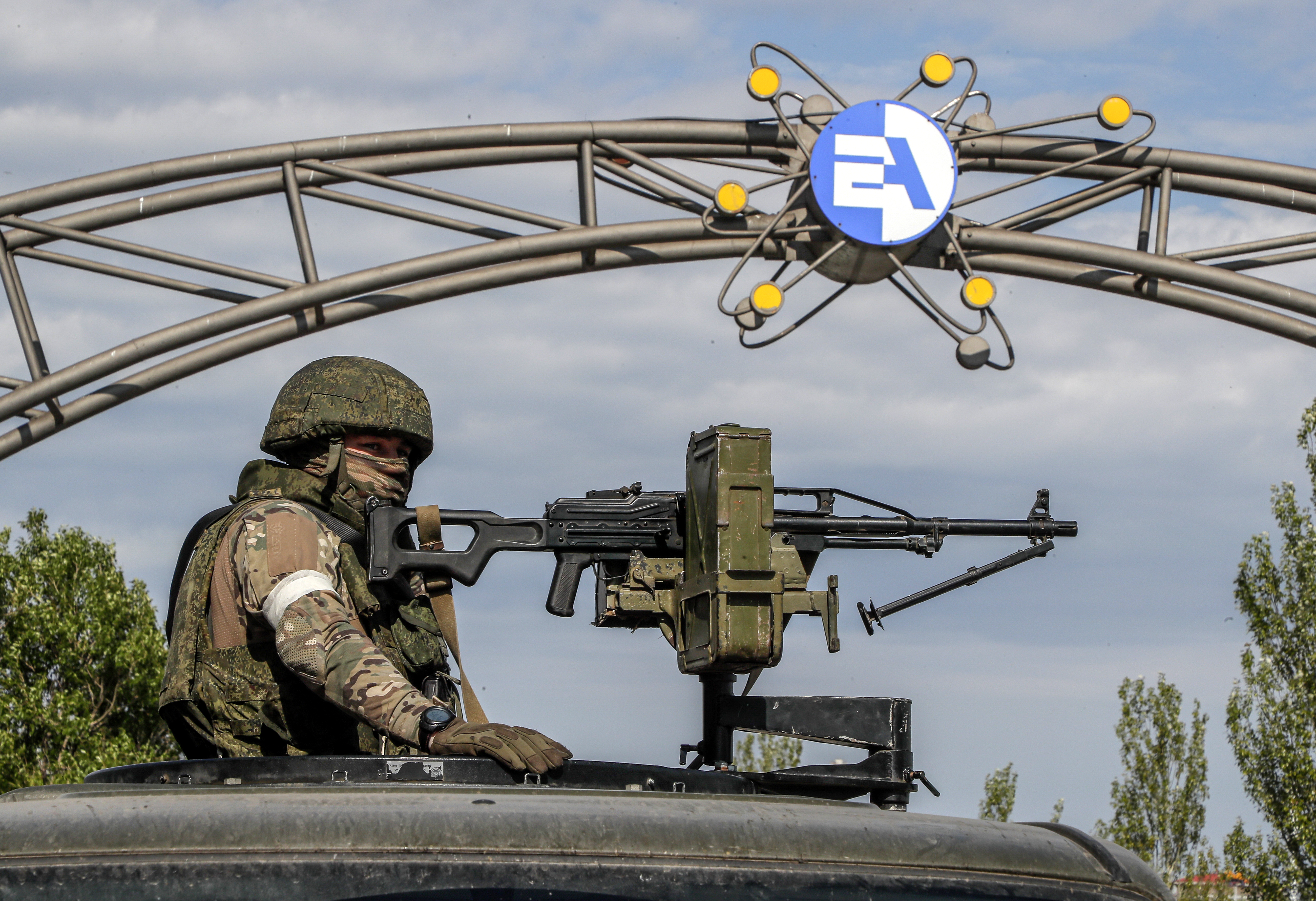 A Russian serviceman on guard in front of the main entrance of the Zaporizhzhia Nuclear Power Station.