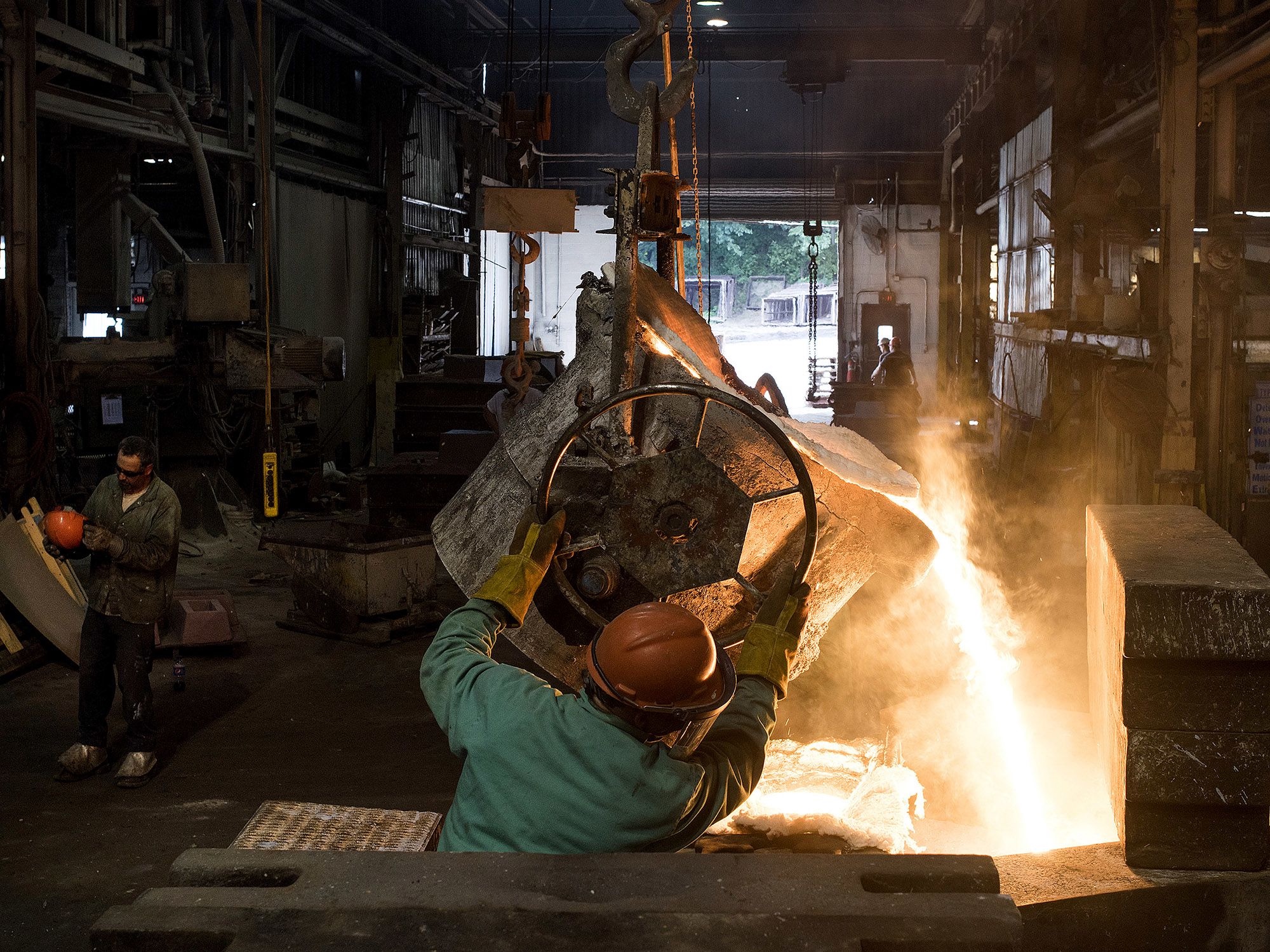 Molten steel is poured from a ladle into a large mold at a castings facility in Salem, Ohio