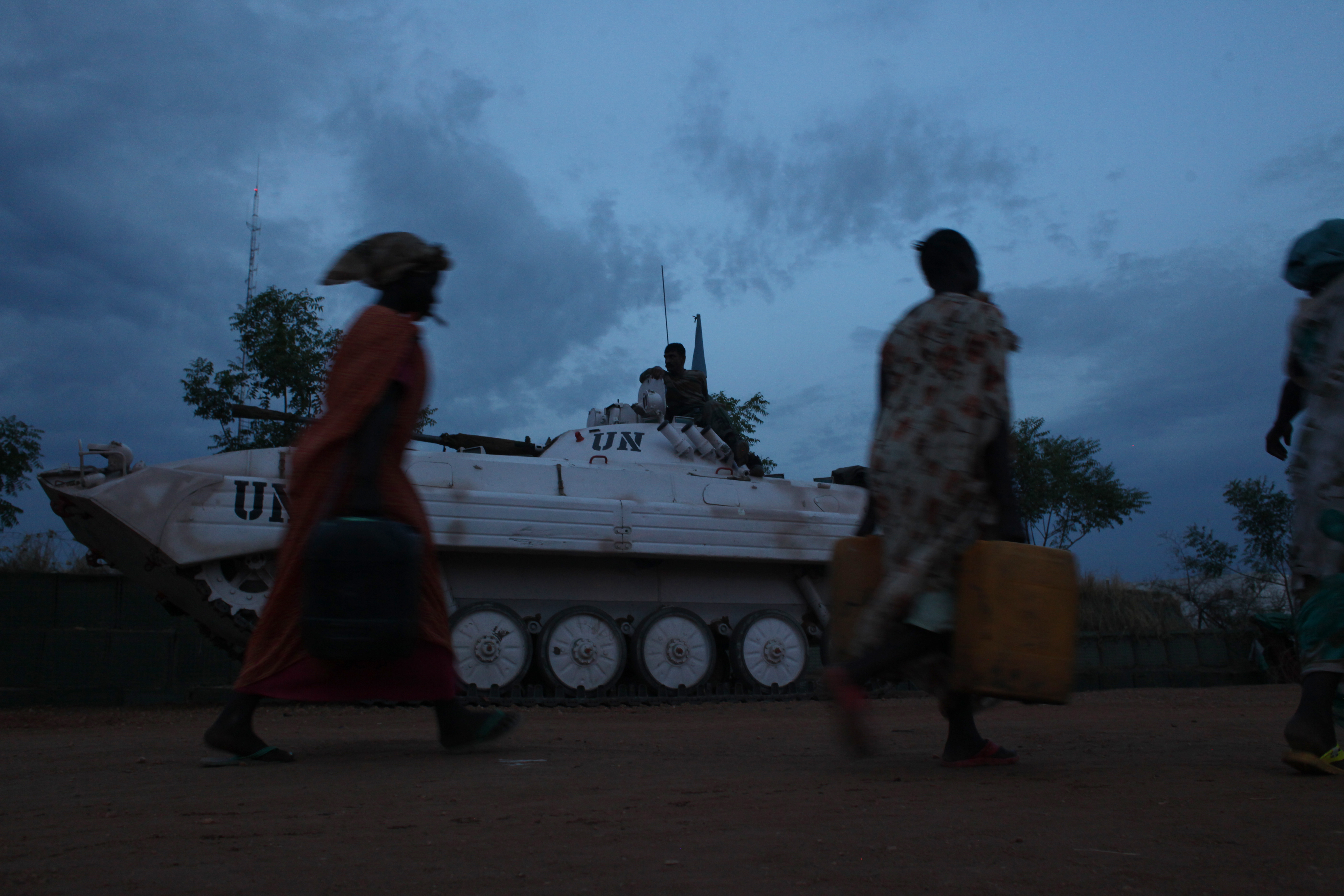 Women walk past a UN tank inside the inside de POC (protection of civilians site) in Malakal, South Sudan