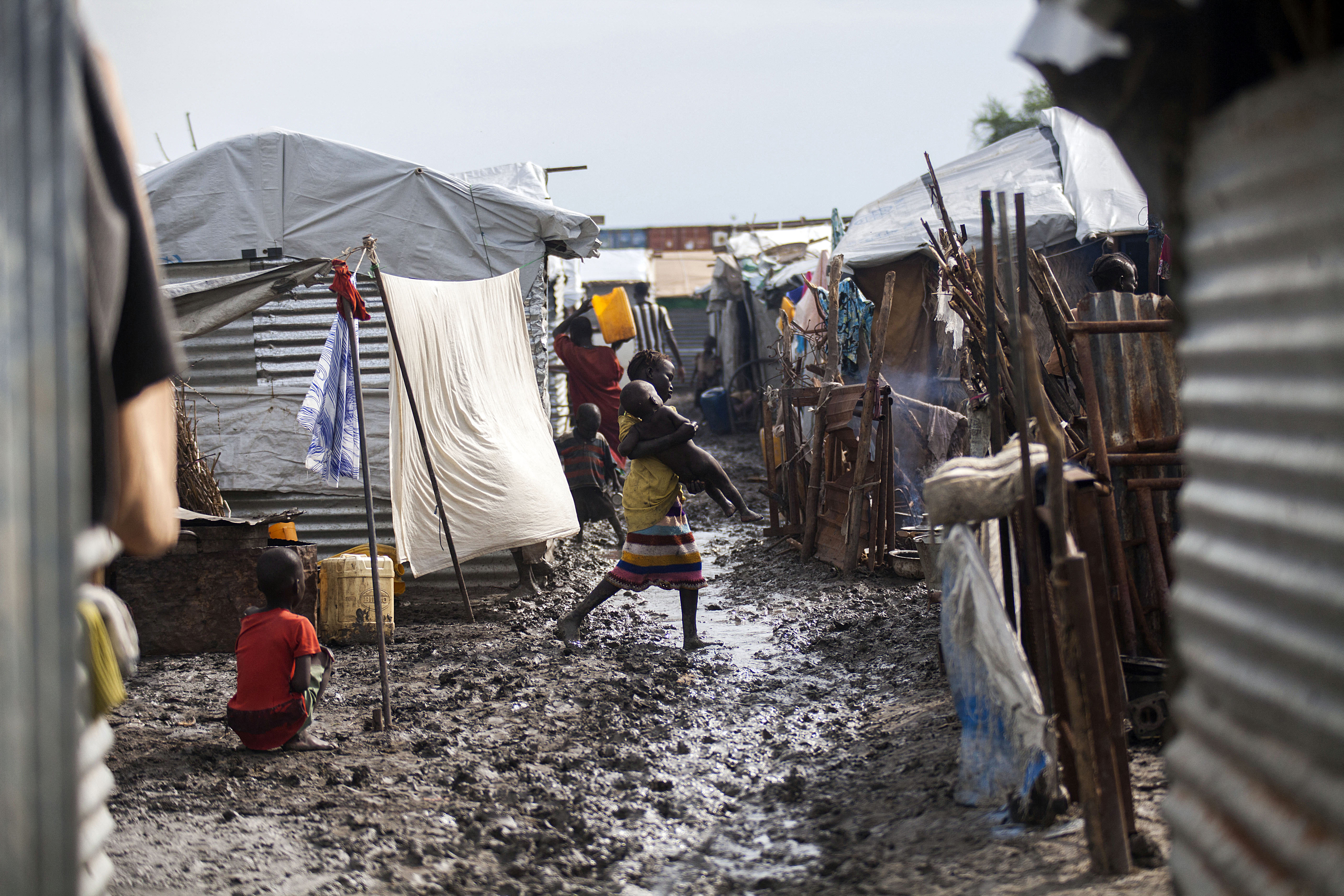 A child carries her young relative in the Protection of Civilians (PoC) site in Malakal, on June 14, 2016