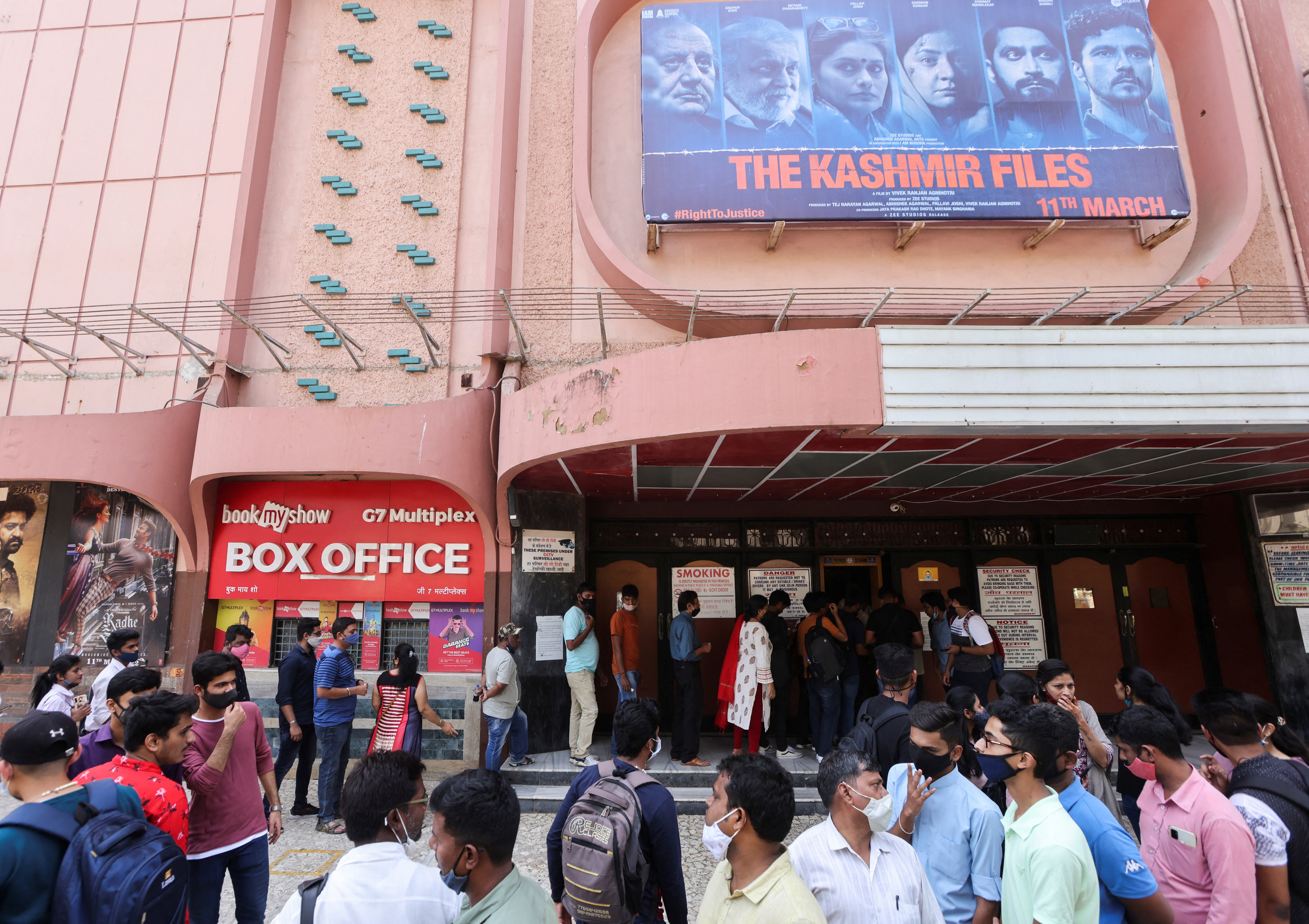 People wait in line to enter a G7 Multiplex cinema to watch the Bollywood movie "The Kashmir Files", in Mumbai, India, March 17, 2022.