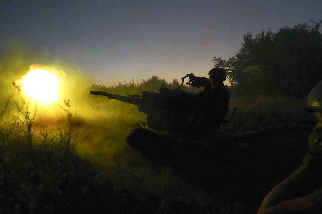 Ukrainian servicemen fire anti-aircraft gun