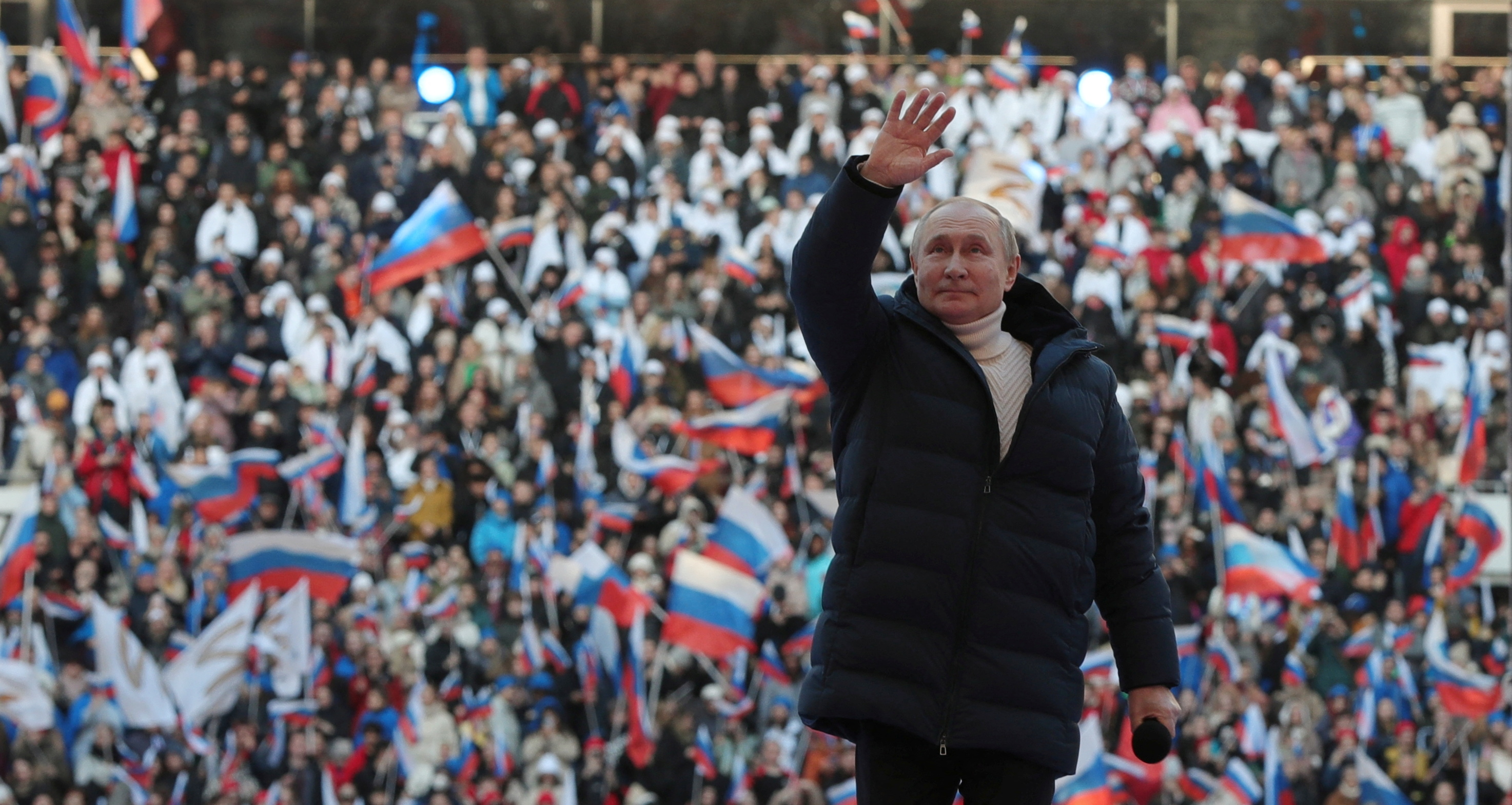 Russian President Vladimir Putin waves during a concert marking the eighth anniversary of Russia's annexation of Crimea at Luzhniki Stadium in Moscow, Russia March 18, 2022. Sputnik/Mikhail Klimentyev/Kremlin via REUTERS ATTENTION EDITORS - THIS IMAGE WAS PROVIDED BY A THIRD PARTY.