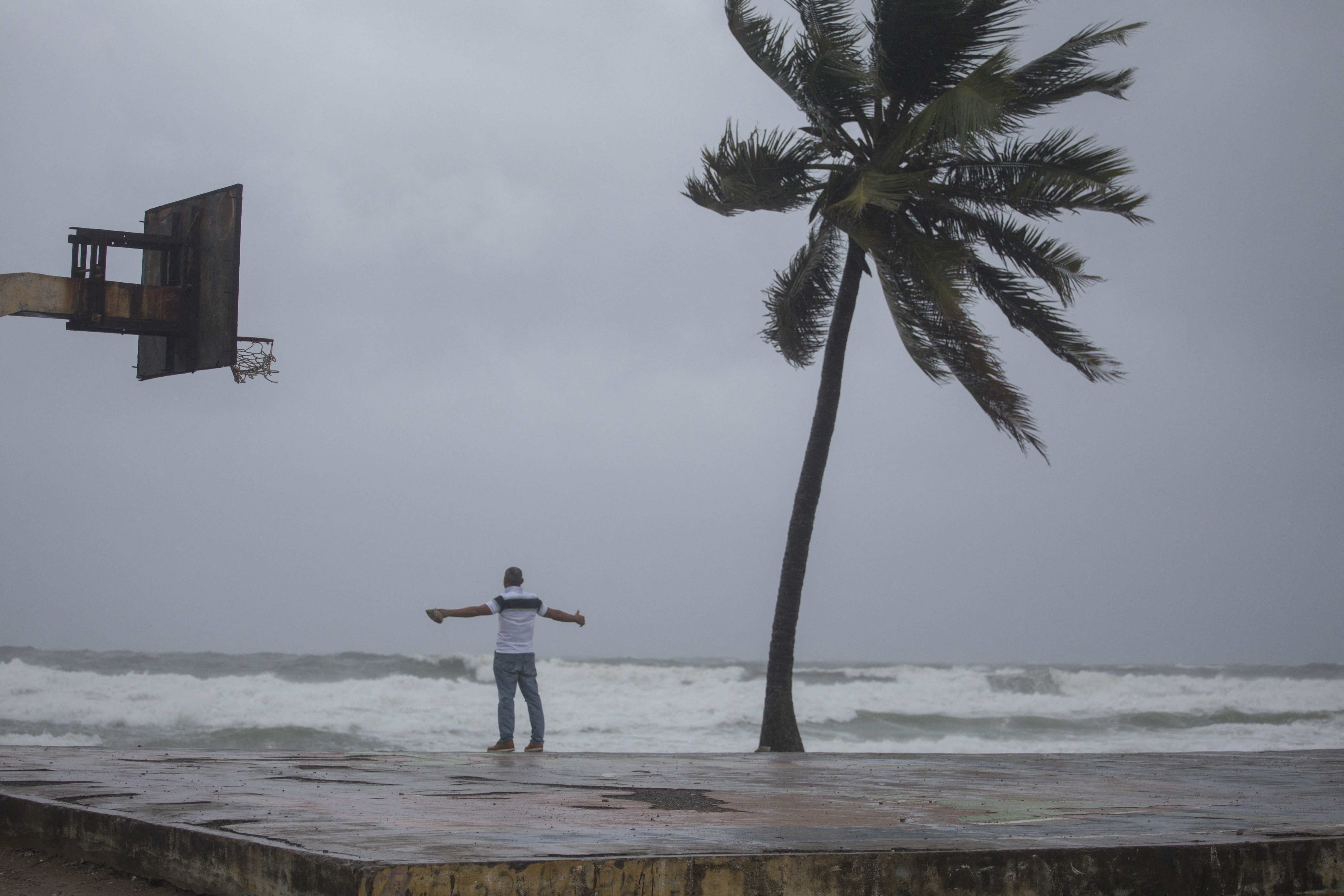A man looks at the sea at the beach in Nagua, Dominican Republic
