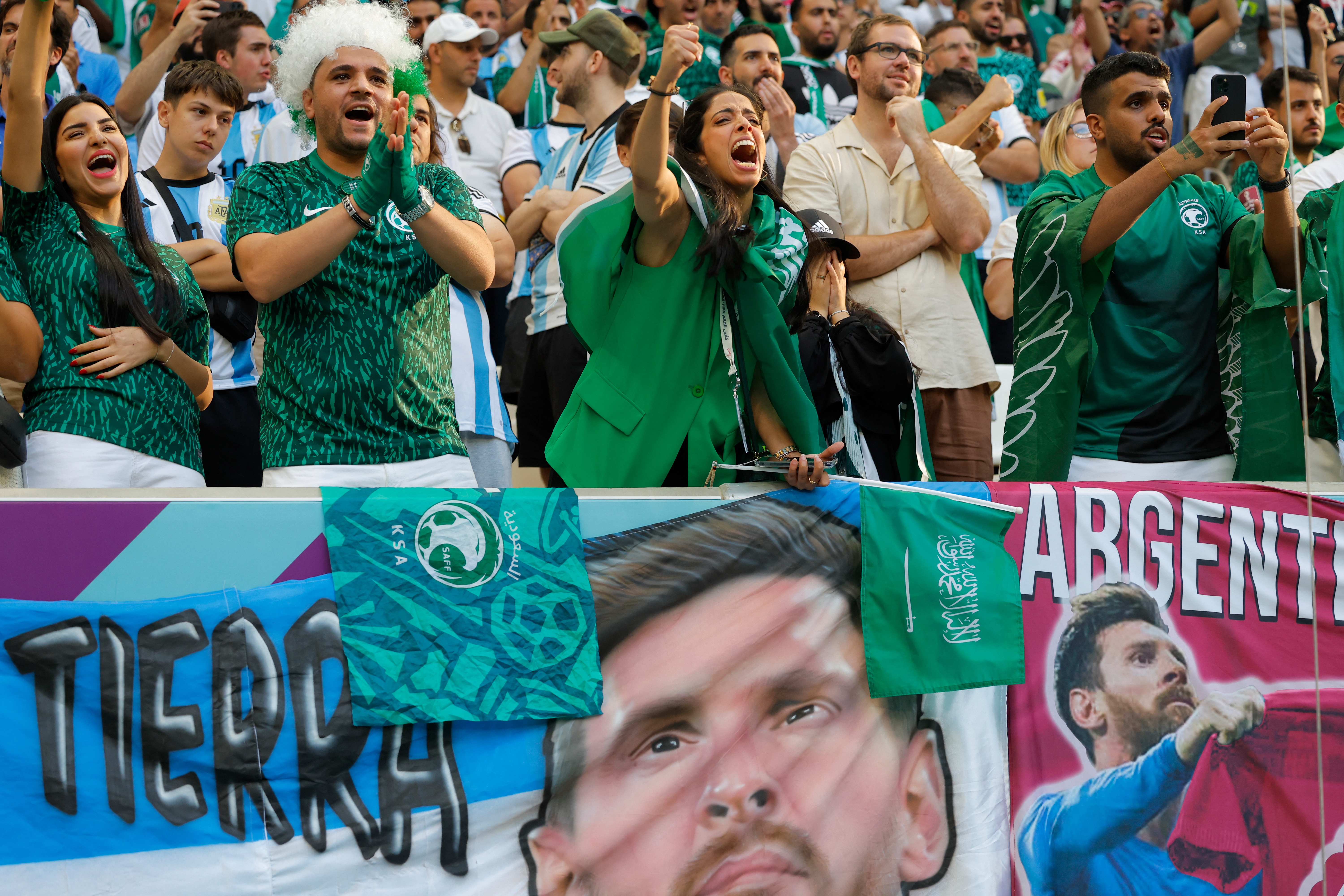 Saudi fans with a Messi banner
