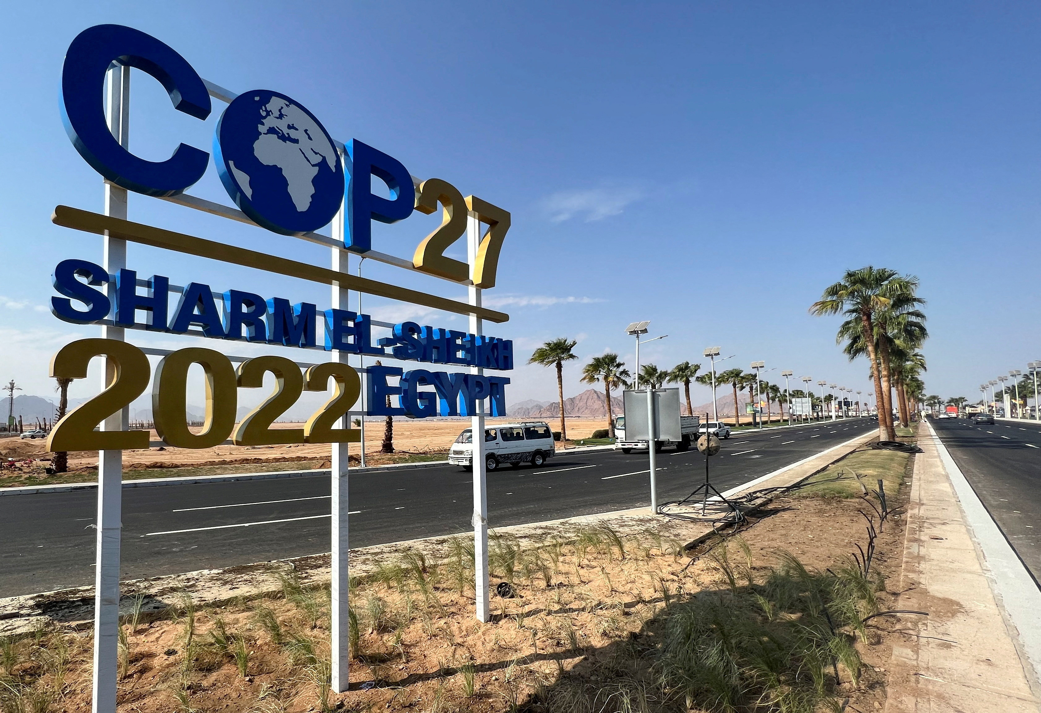 View of a COP27 sign on the road leading to the conference area in Egypt's Red Sea resort.