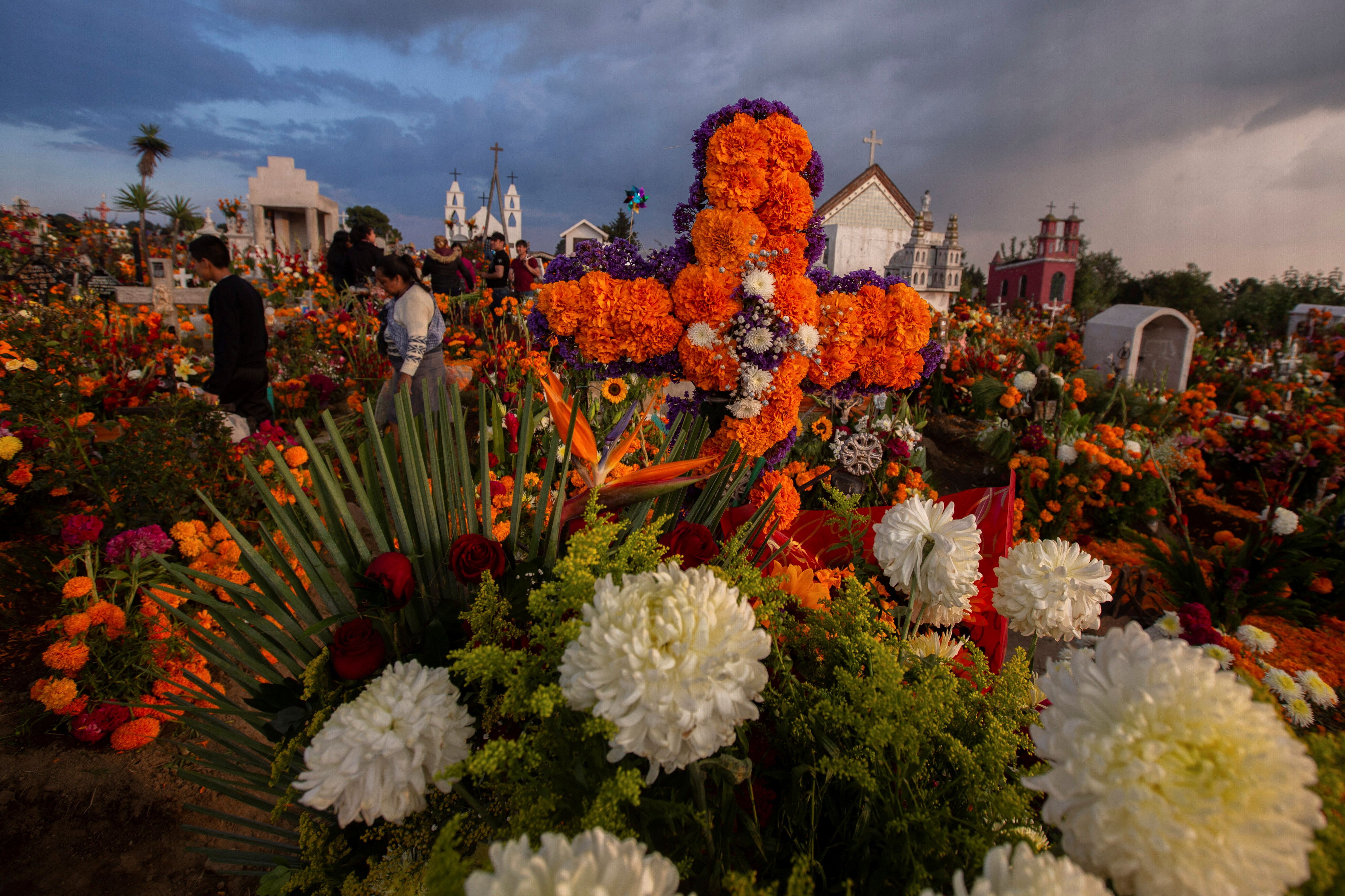 Indigenous people decorate the graves of their loved ones