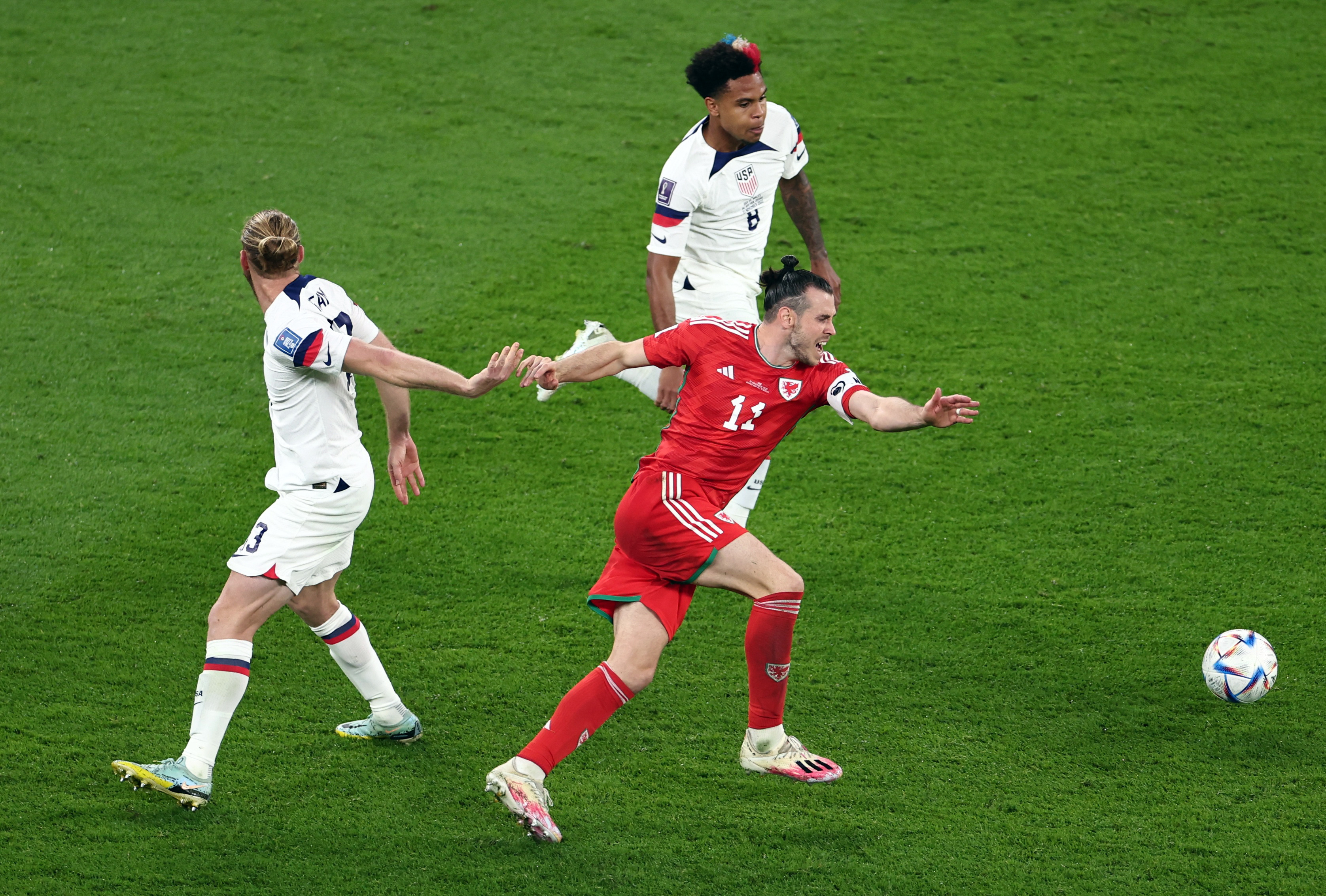 Wales's Gareth Bale in action with Tim Ream and Weston McKennie of the USA.