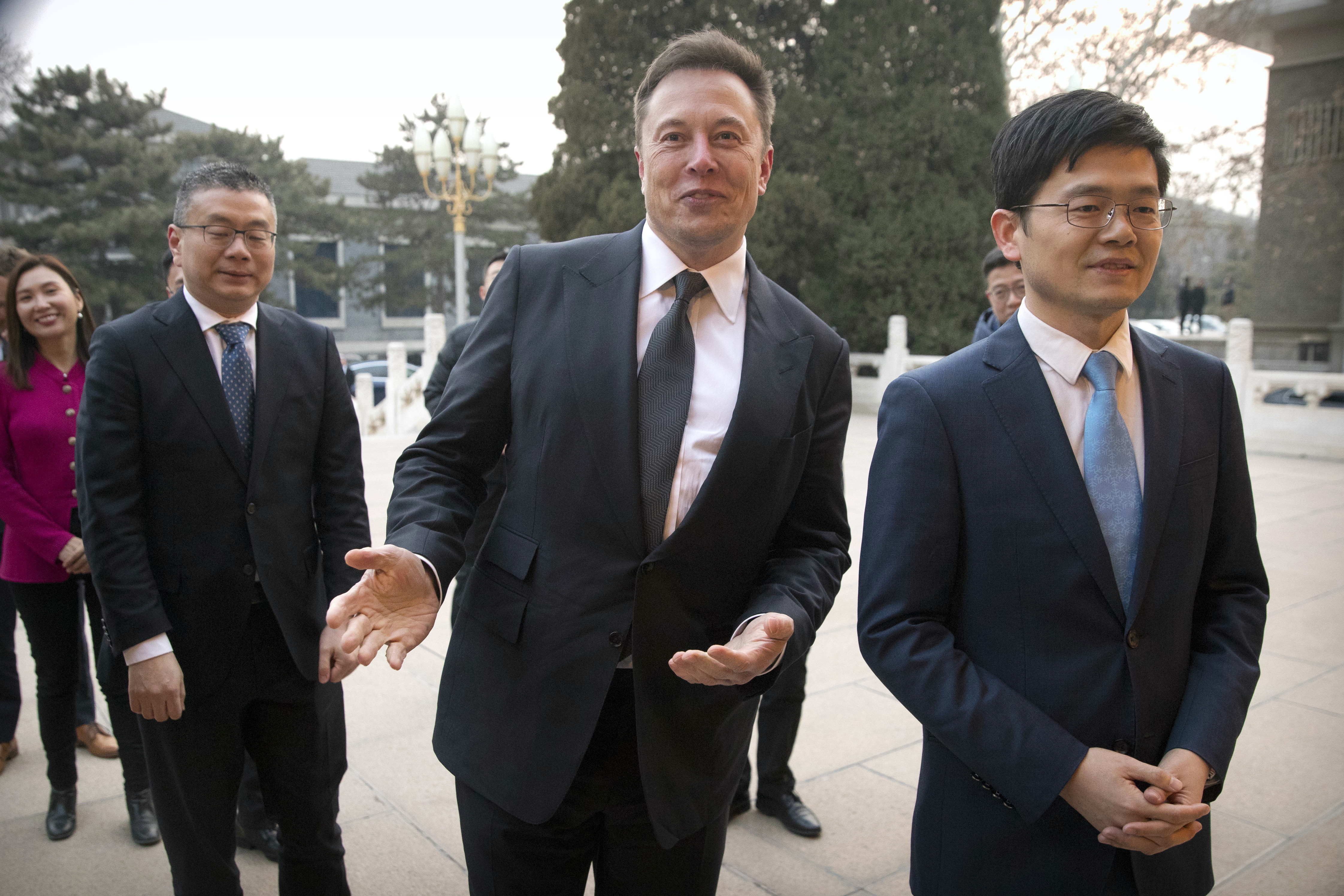 FILE - Tesla CEO Elon Musk, center, gestures as he waits for a meeting with Chinese Premier Li Keqiang at the Zhongnanhai leadership compound in Beijing, Wednesday, Jan. 9, 2019. Many people are puzzled on what a Elon Musk takeover of Twitter would mean for the company and even whether he’ll go through with the deal.  If the 50-year-old Musk’s gambit has made anything clear it’s that he thrives on contradiction. (AP Photo/Mark Schiefelbein, Pool, File)