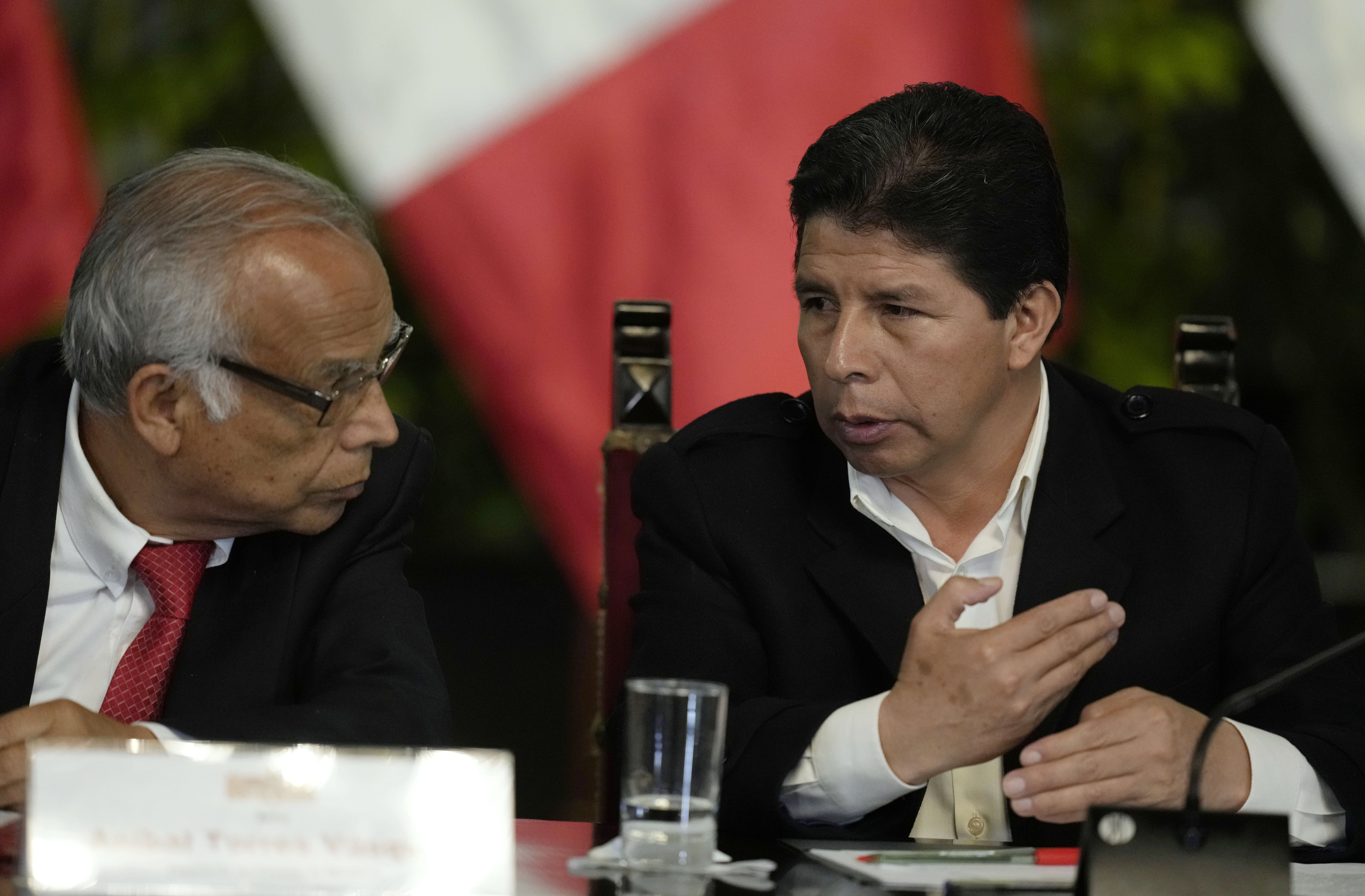 Peru´s President Pedro Castillo talks with his Prime Minister Anibal Torres as they attend a press conference
