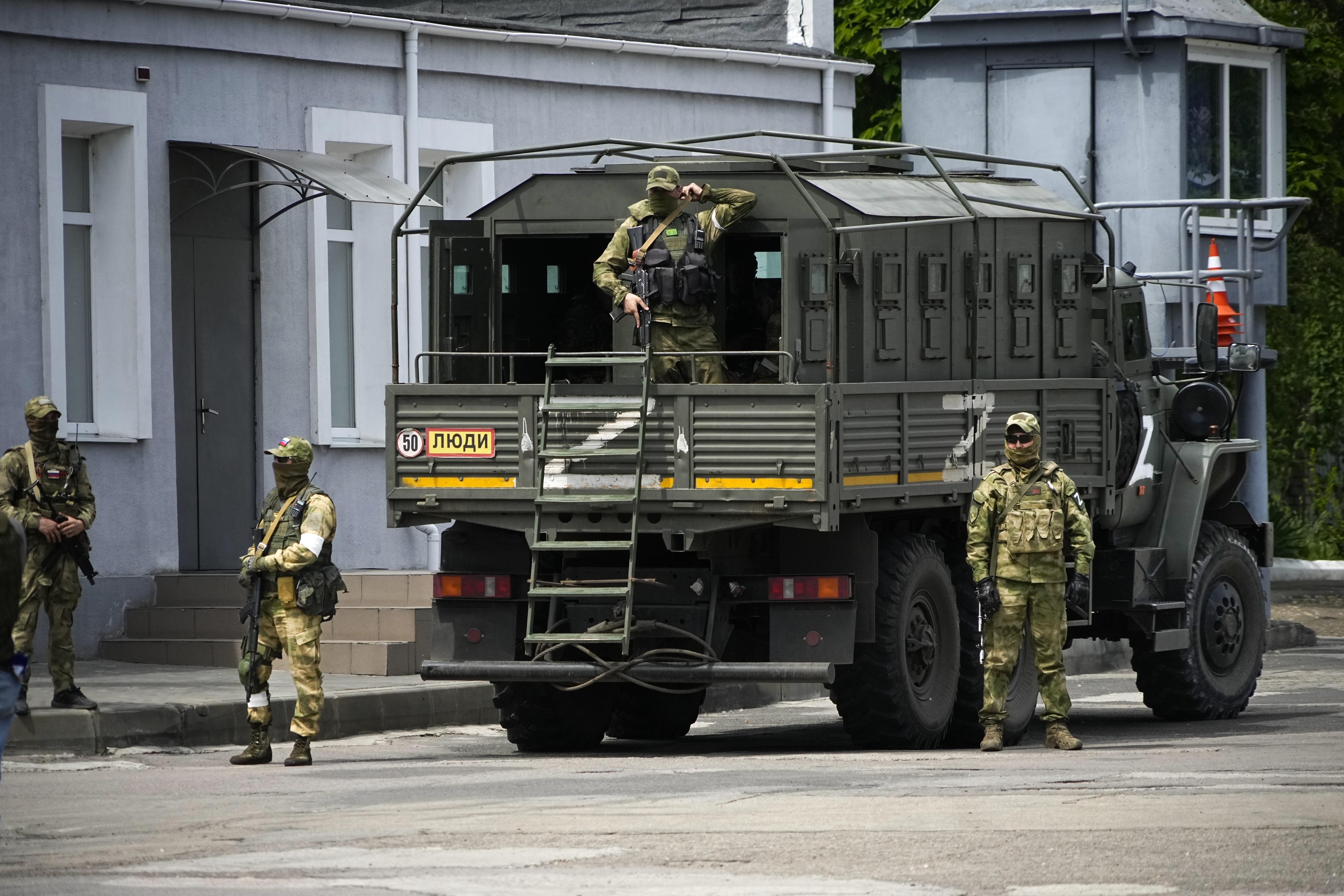 Russian soldiers are seen standing guard in Kherson