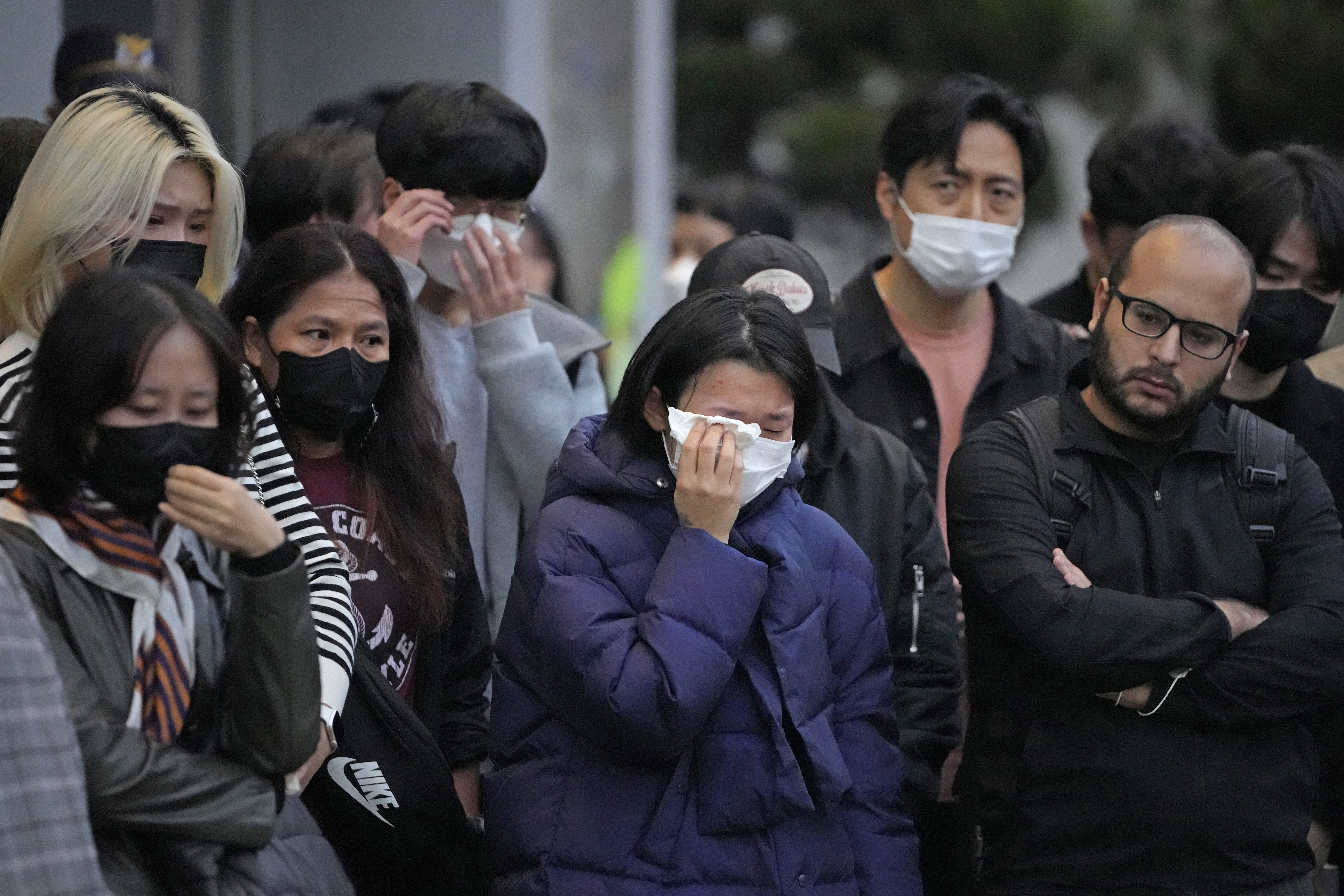 Mourners gather as they pay tribute for victims of a deadly accident following Saturday night's Halloween festivities on the street near the scene in Seoul, South Korea, Monday, Oct. 31, 2022.