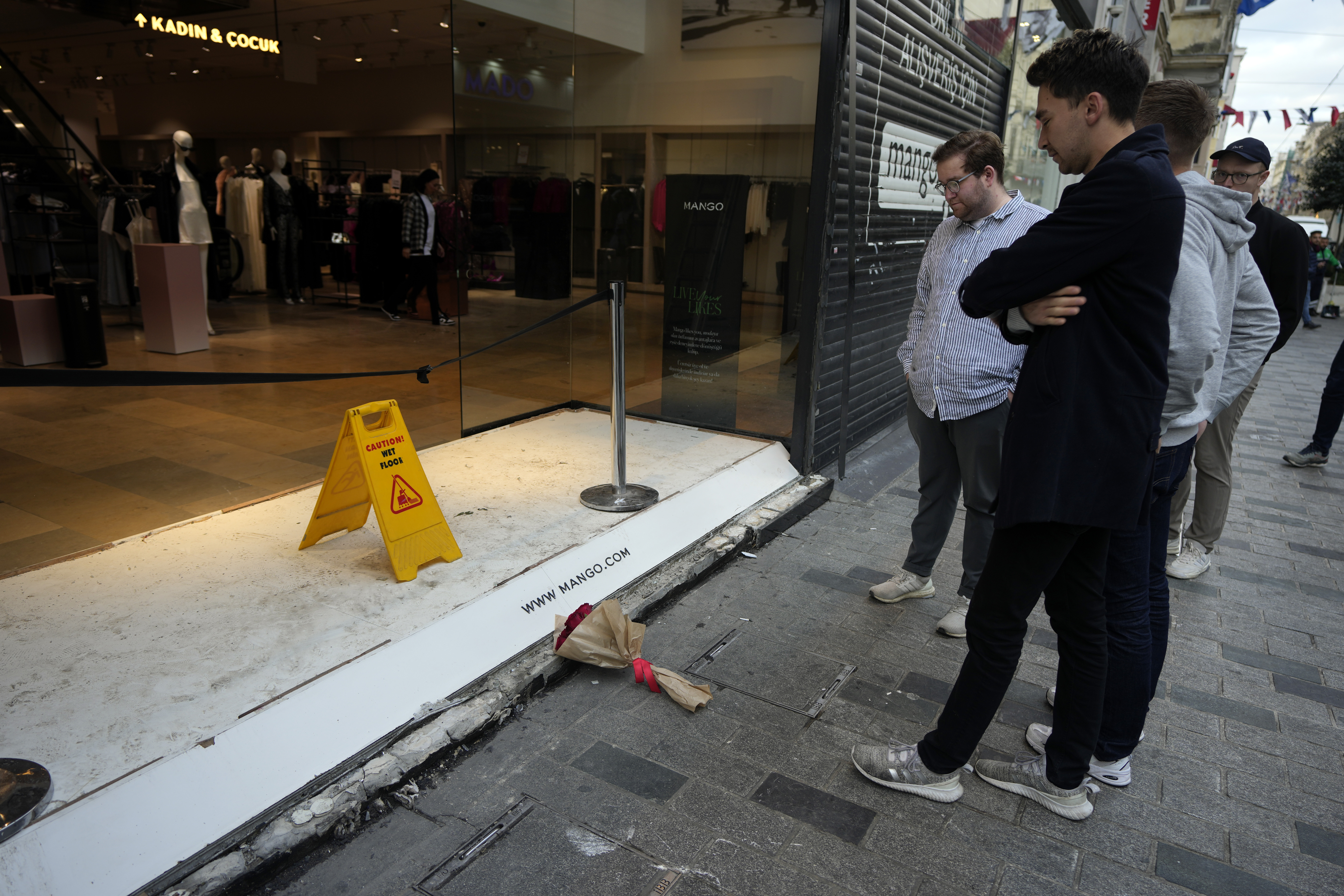 People view the spot of Sunday's explosion on Istanbul's popular Istiklal Avenue