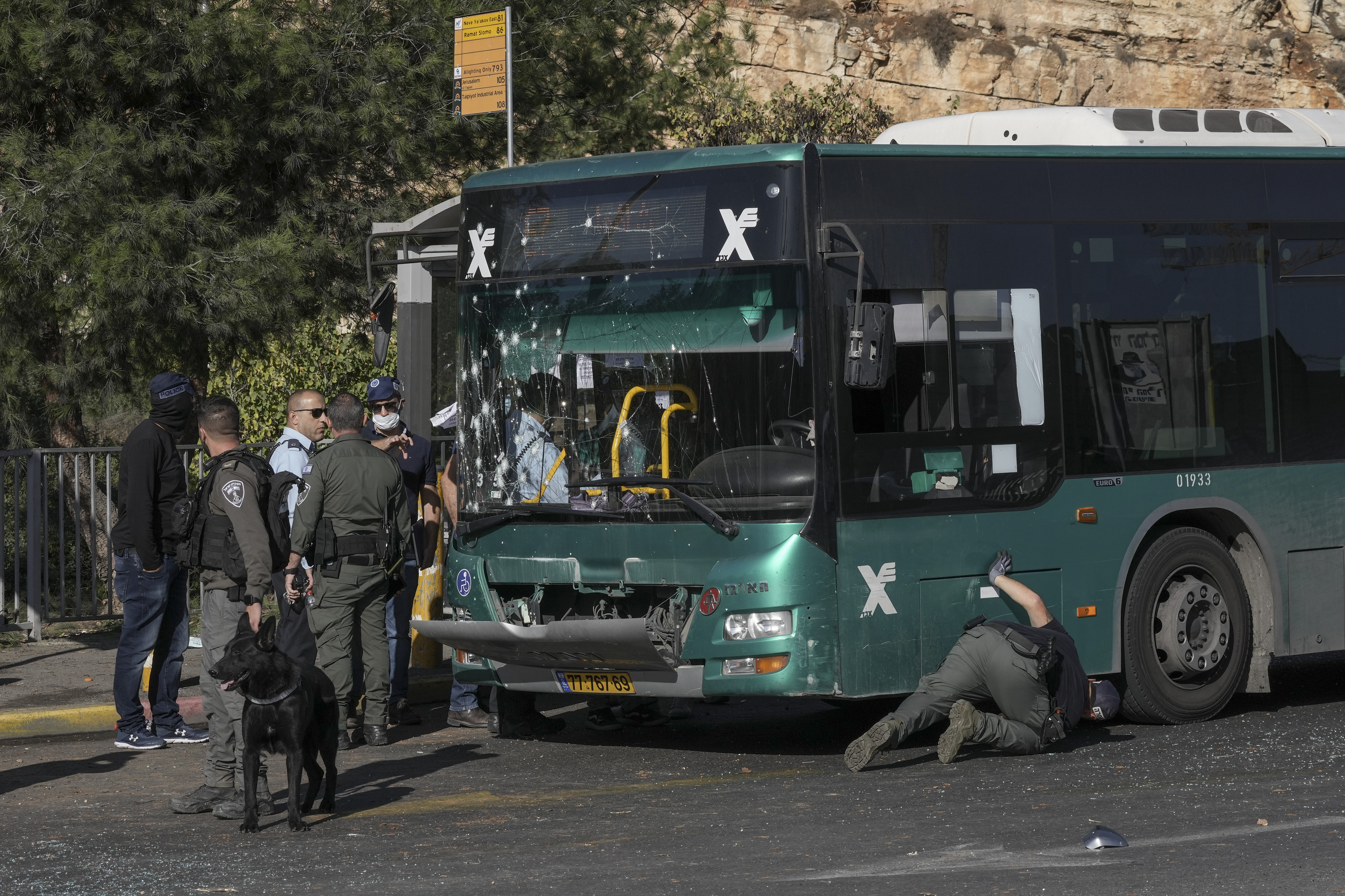 Israeli police inspect the scene of an explosion at a bus stop in Jerusalem