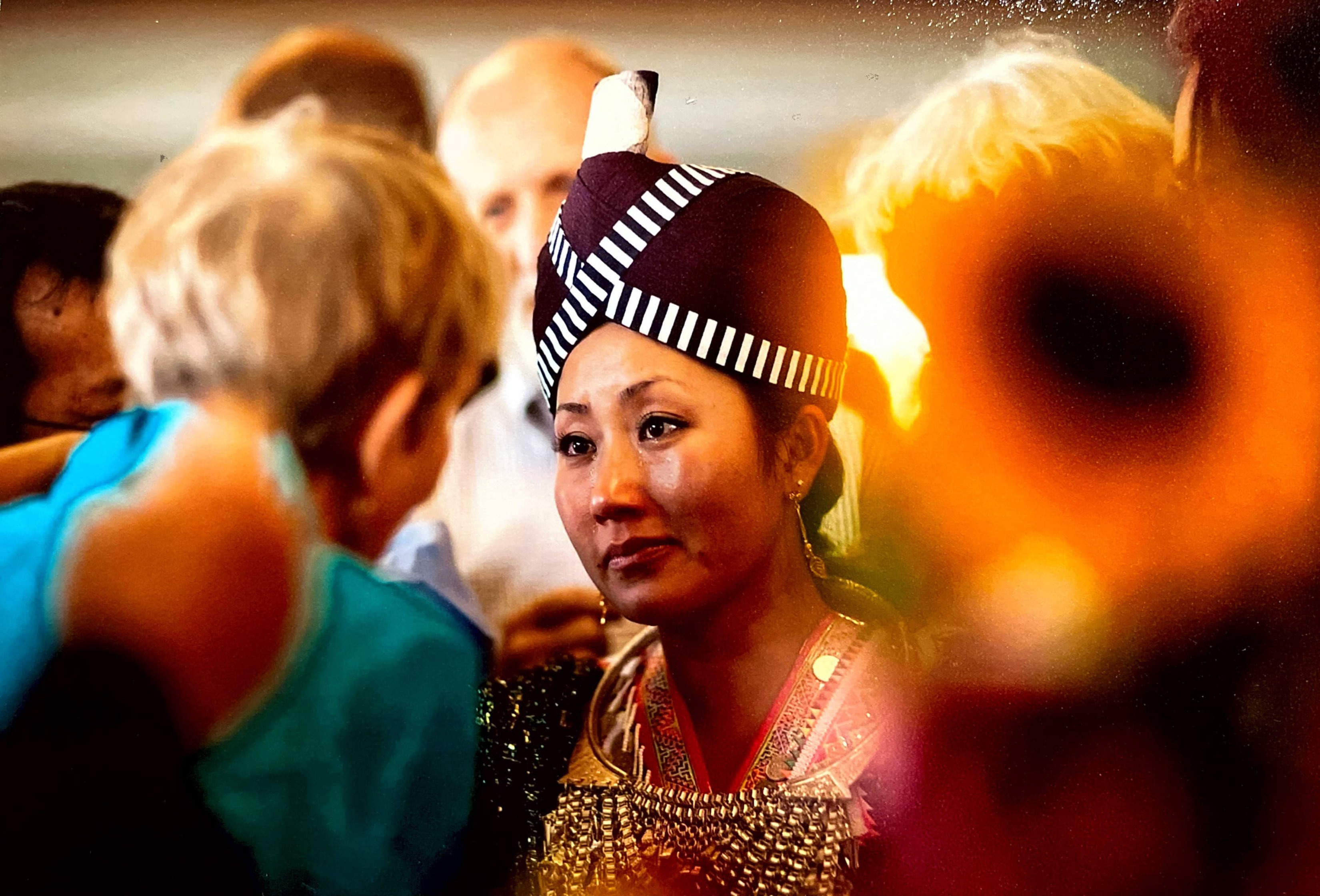 A photo of two people standing in front of each other, talking.