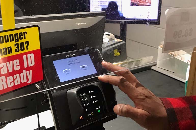 A photo of someone at a self checkout.