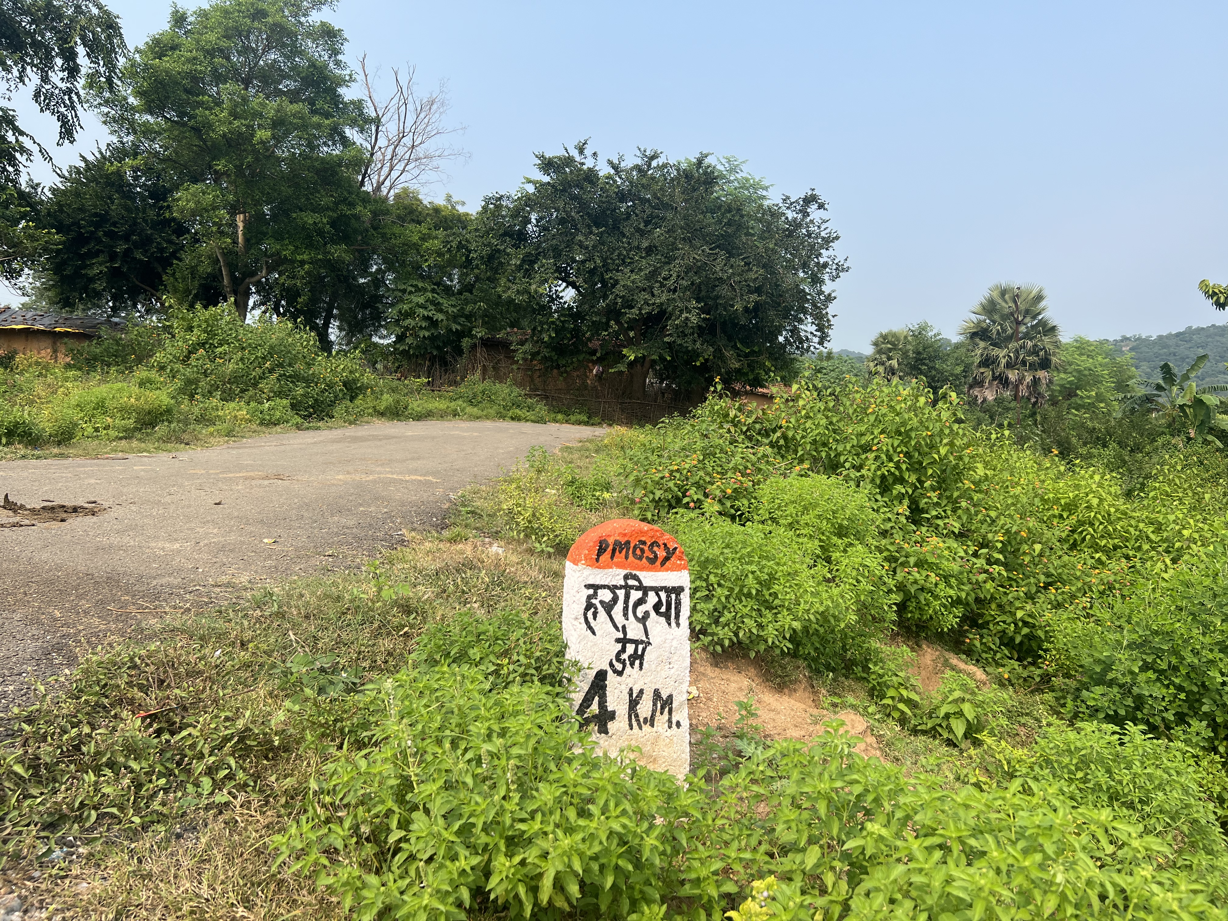 A photo of a road sign with "4 K.M." written on it.