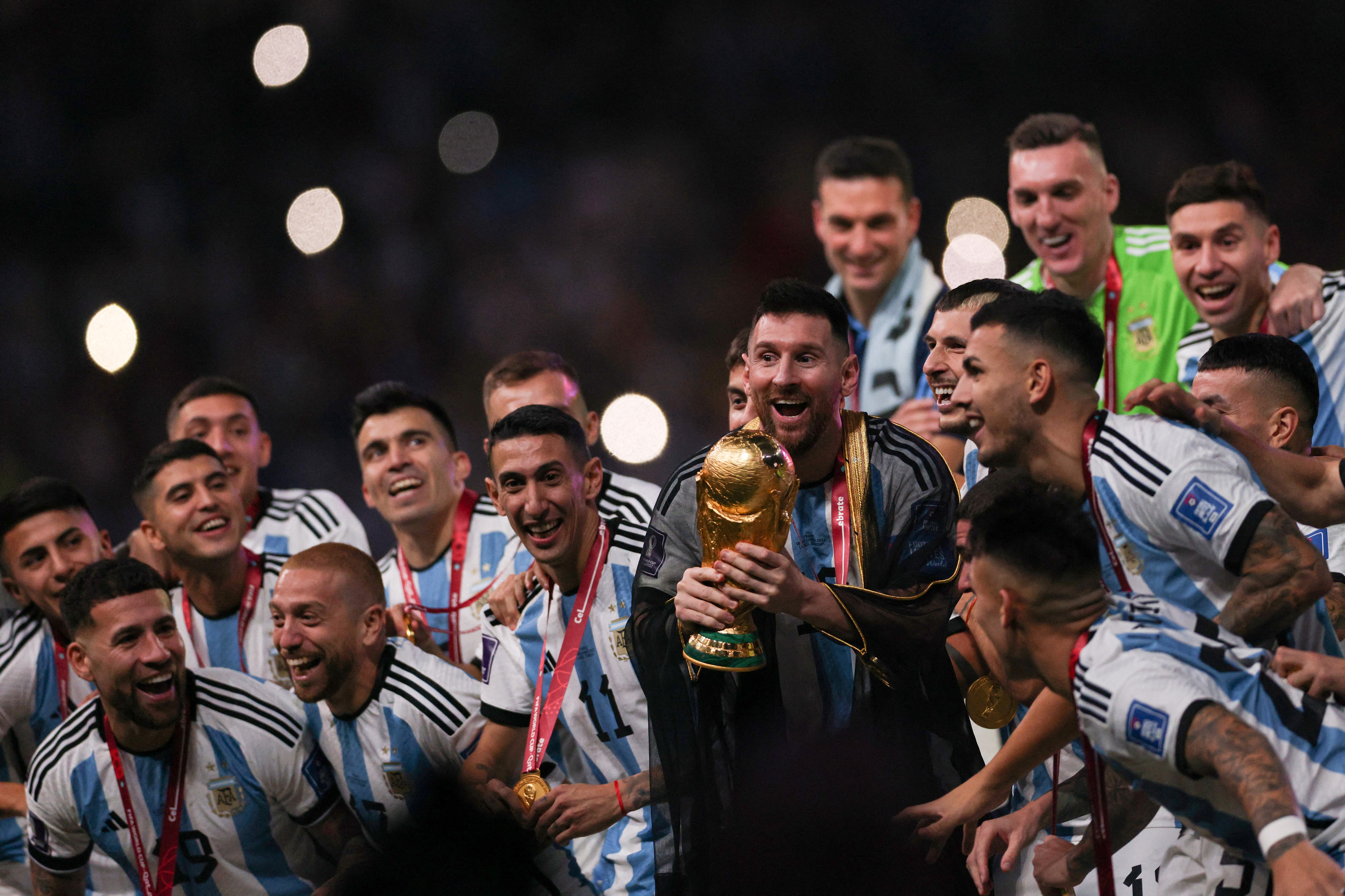 Argentina's captain and forward #10 Lionel Messi lifts the FIFA World Cup Trophy during the trophy ceremony after Argentina won the Qatar 2022 World Cup final football match between Argentina and France at Lusail Stadium in Lusail, north of Doha on December 18, 2022. (Photo by Adrian DENNIS / AFP)