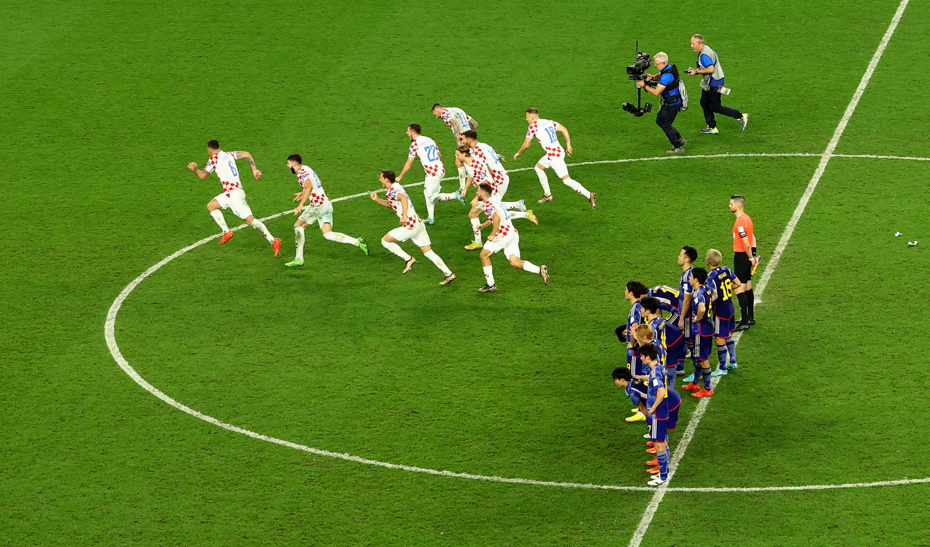 Croatia players celebrate after winning the penalty shootout as Japan players look dejected
