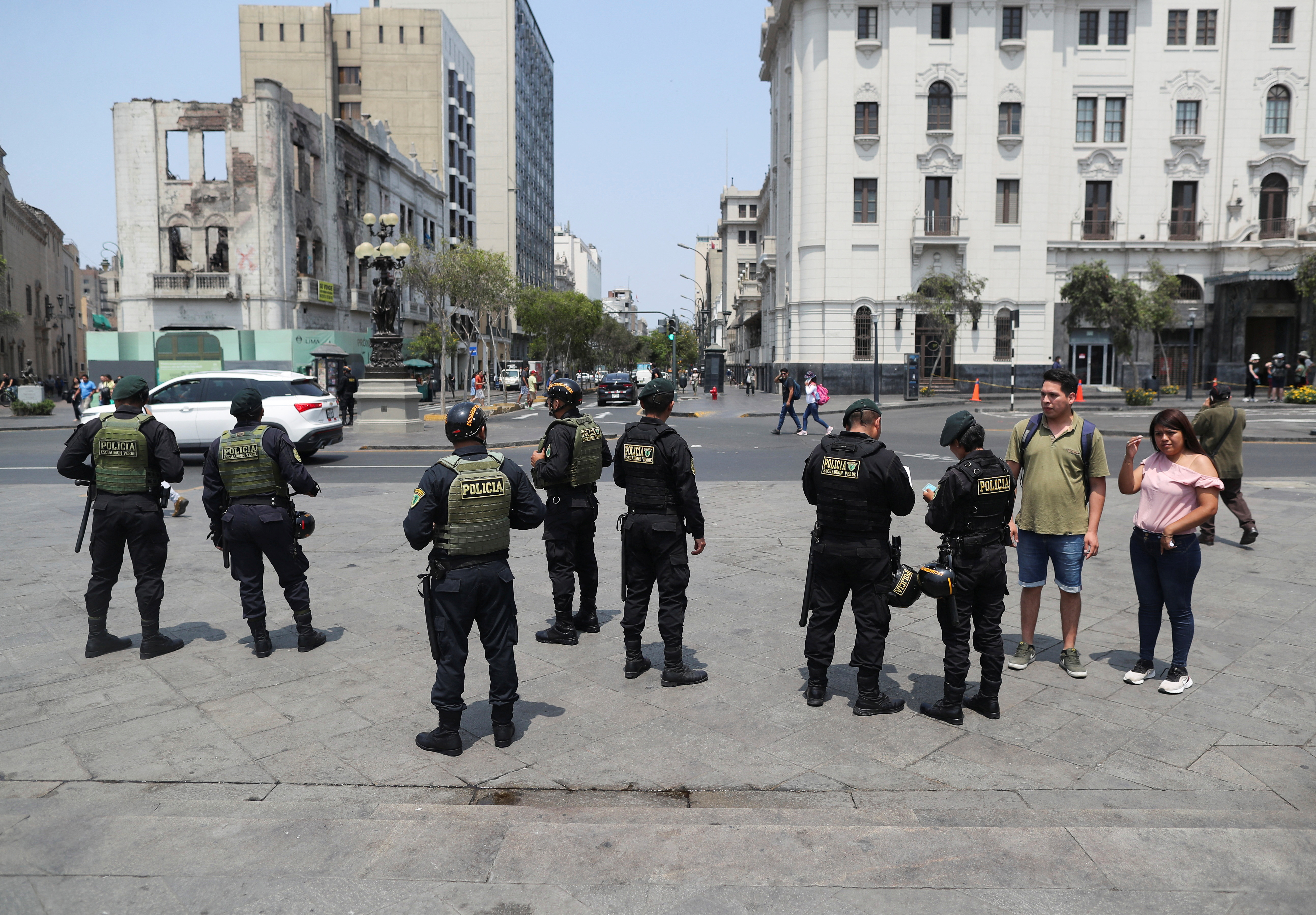 Police officers inspect documents