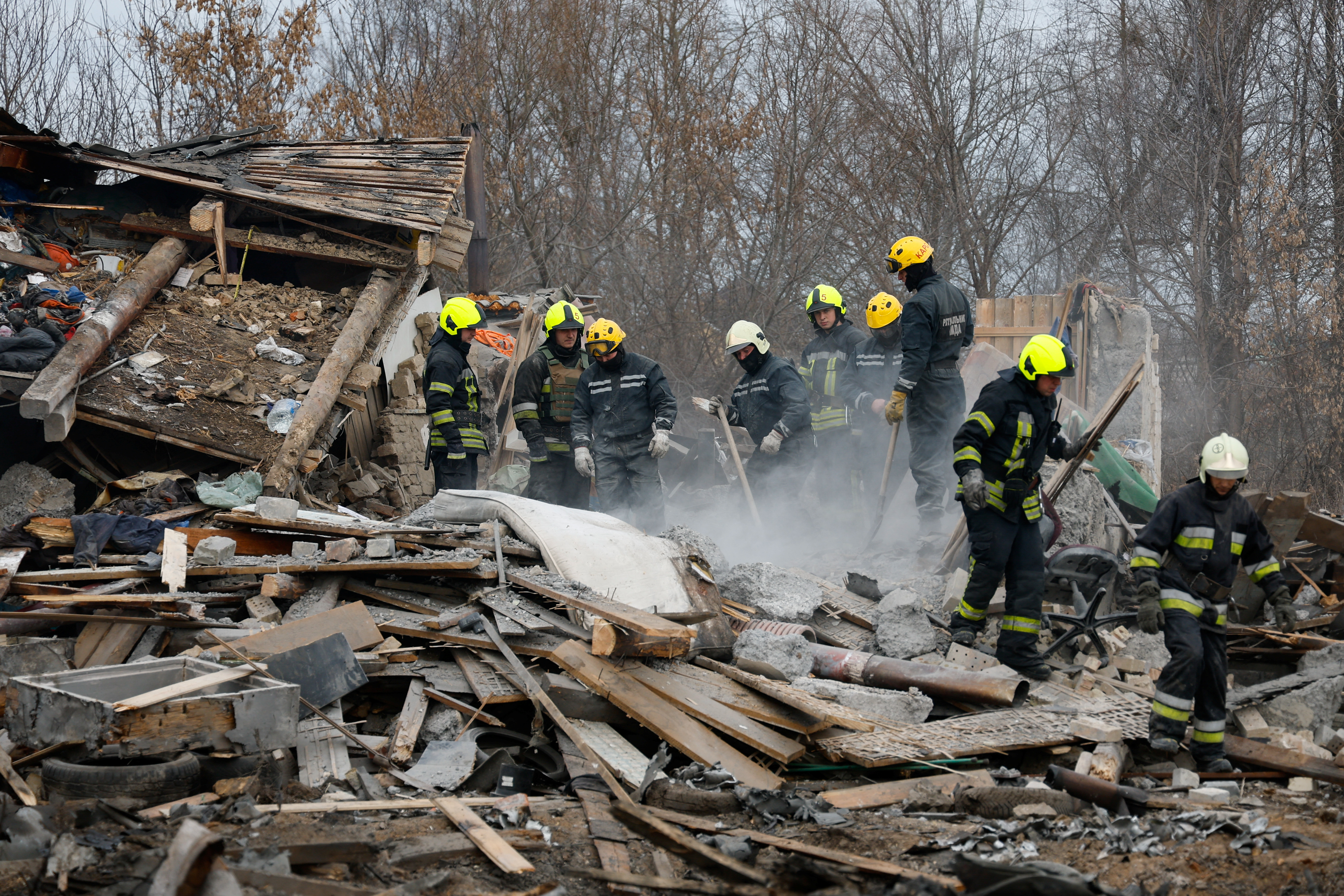 Rescuers work at a site of a residential house damaged during a Russian missile strike in Kyiv