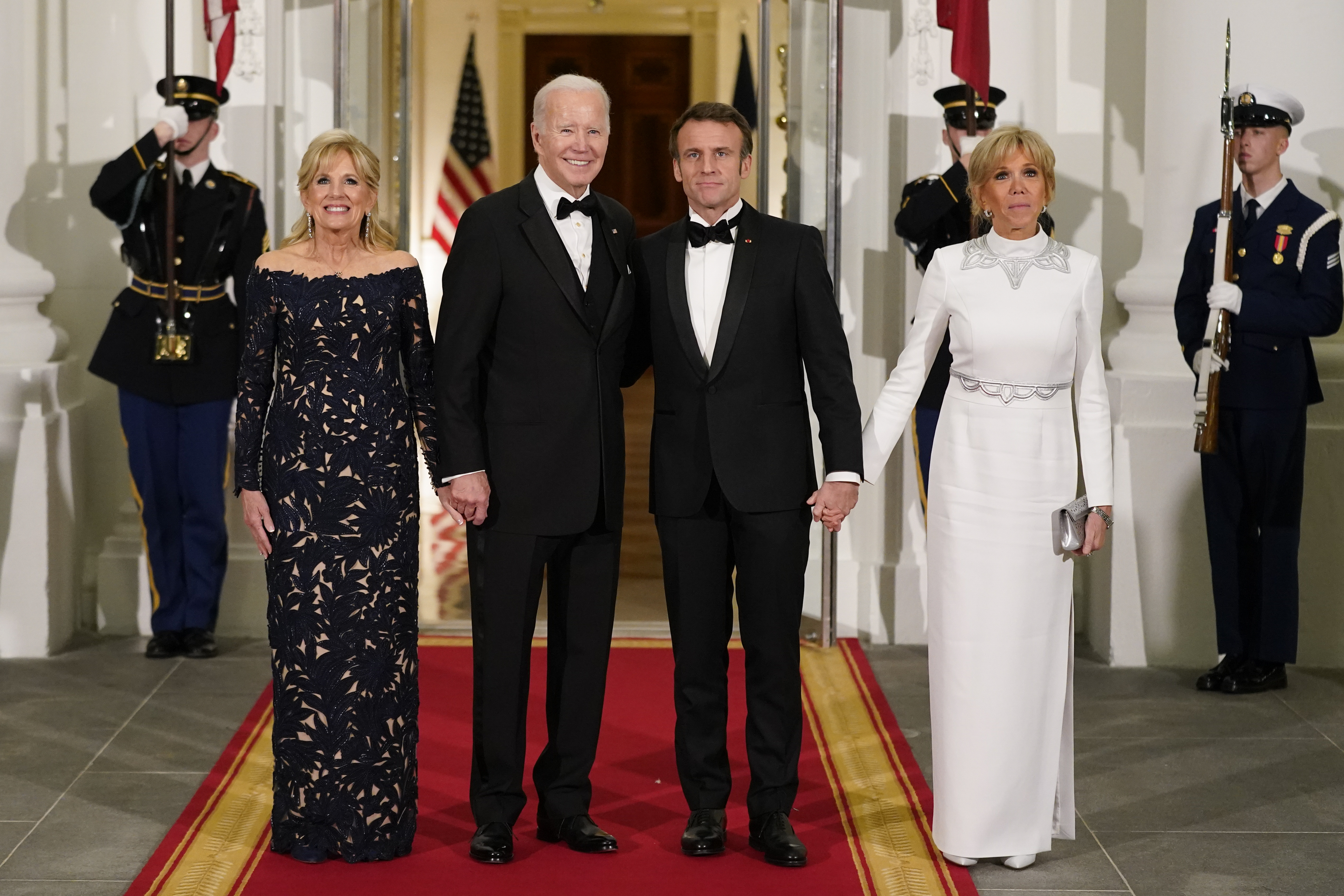 President Joe Biden and first lady Jill Biden pose for photos with French President Emmanuel Macron and his wife Brigitte Macron as they arrive for a State Dinner on the North Portico of the White House in Washington, Thursday, Dec. 1, 2022. (AP Photo/Patrick Semansky)