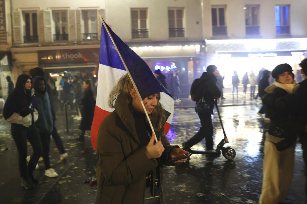 France supporters in the streets of Paris react in sadness after the World Cup final football match between Argentina and France.