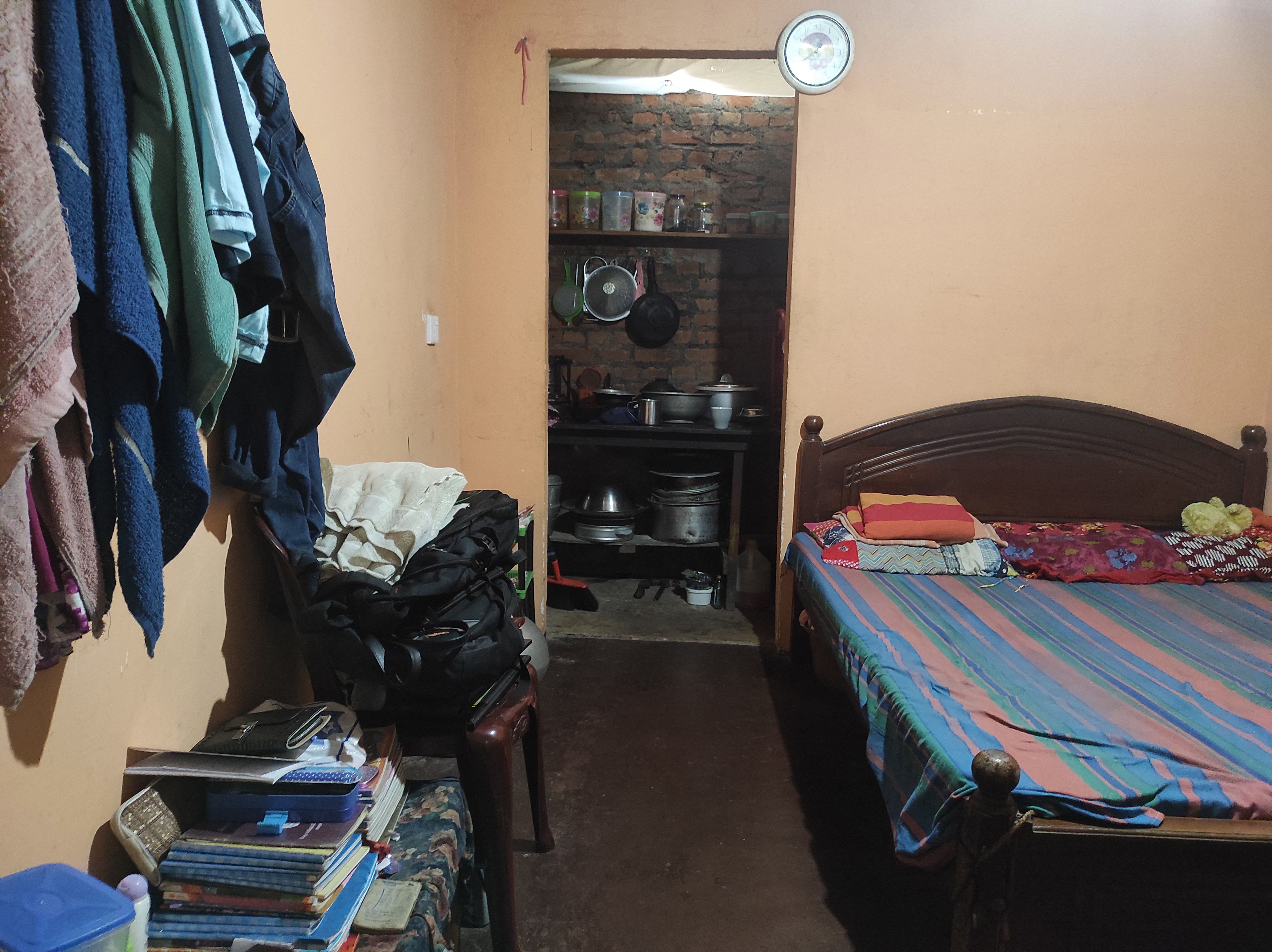 A bedroom next to a small kitchen in Sri Lanka