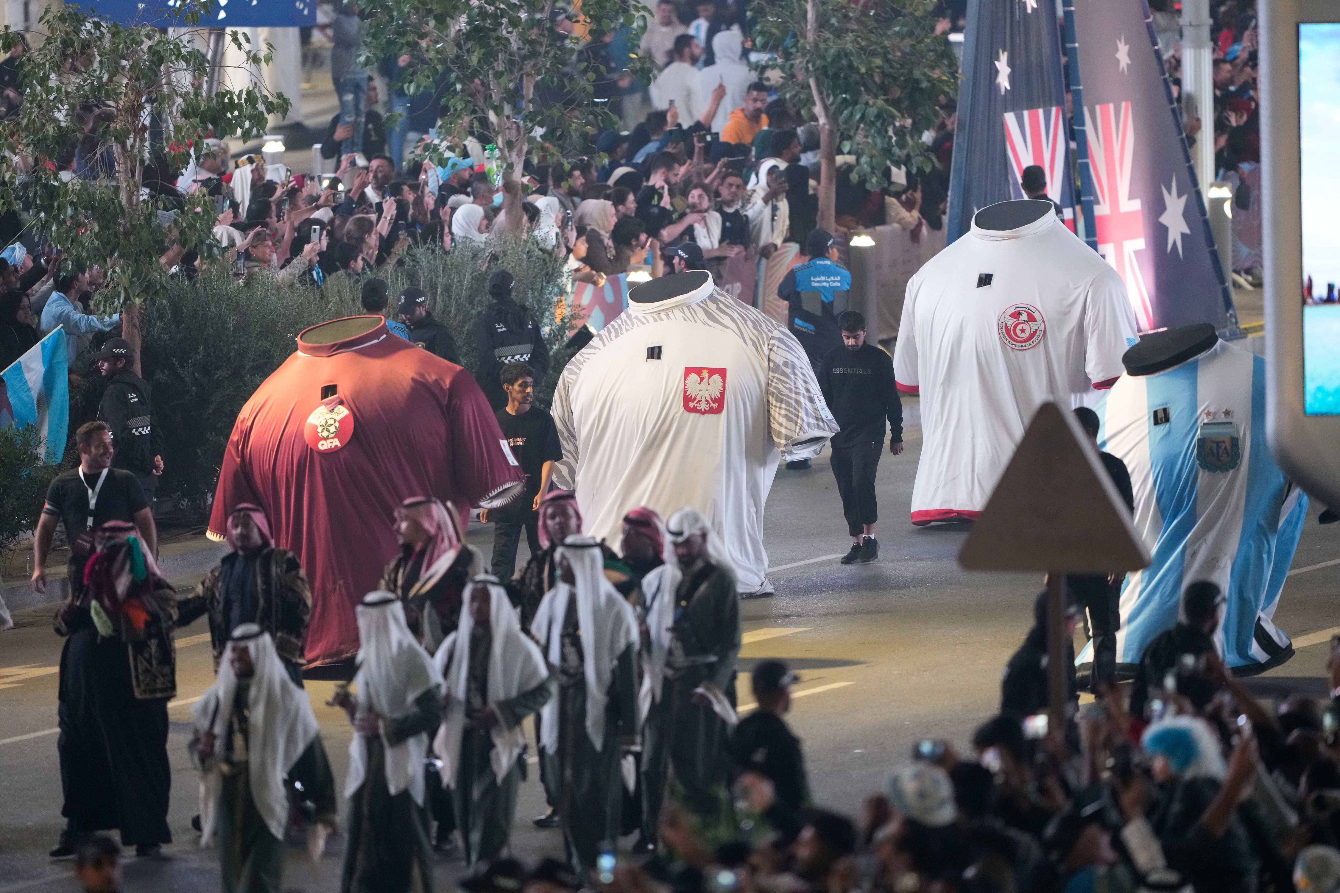 Performers dressed in huge football jerseys representing World Cup participants take part in the victory parade following the final match.