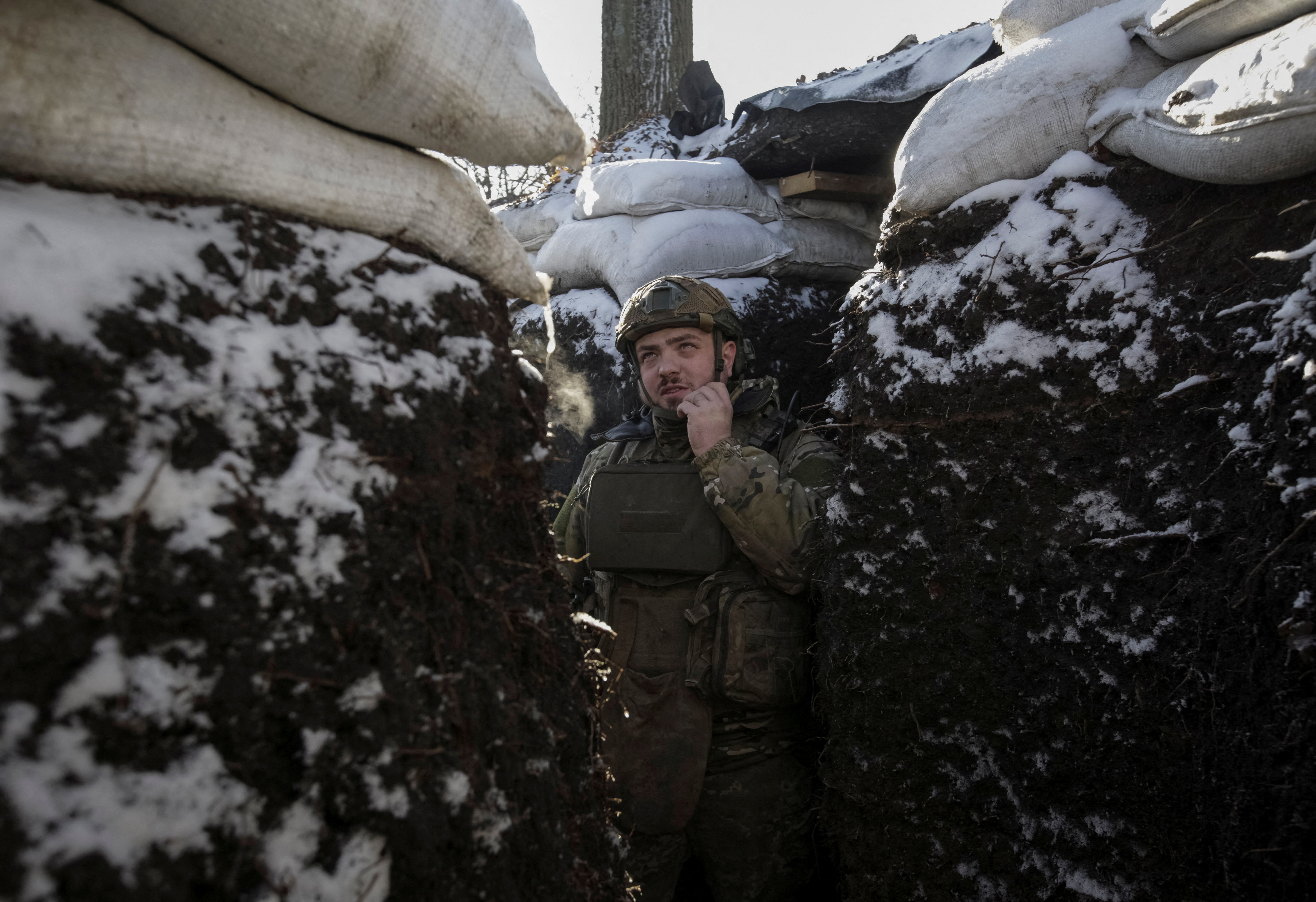 A Ukrainian serviceman stands in a trench on the front line in Donetsk region, Ukraine, January 7, 2023