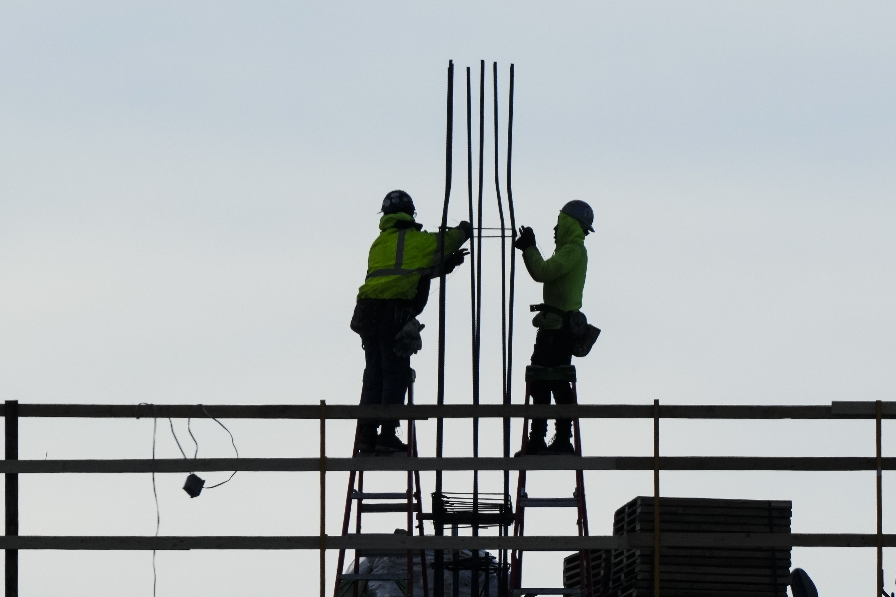 Construction workers work on a building in Philadelphia