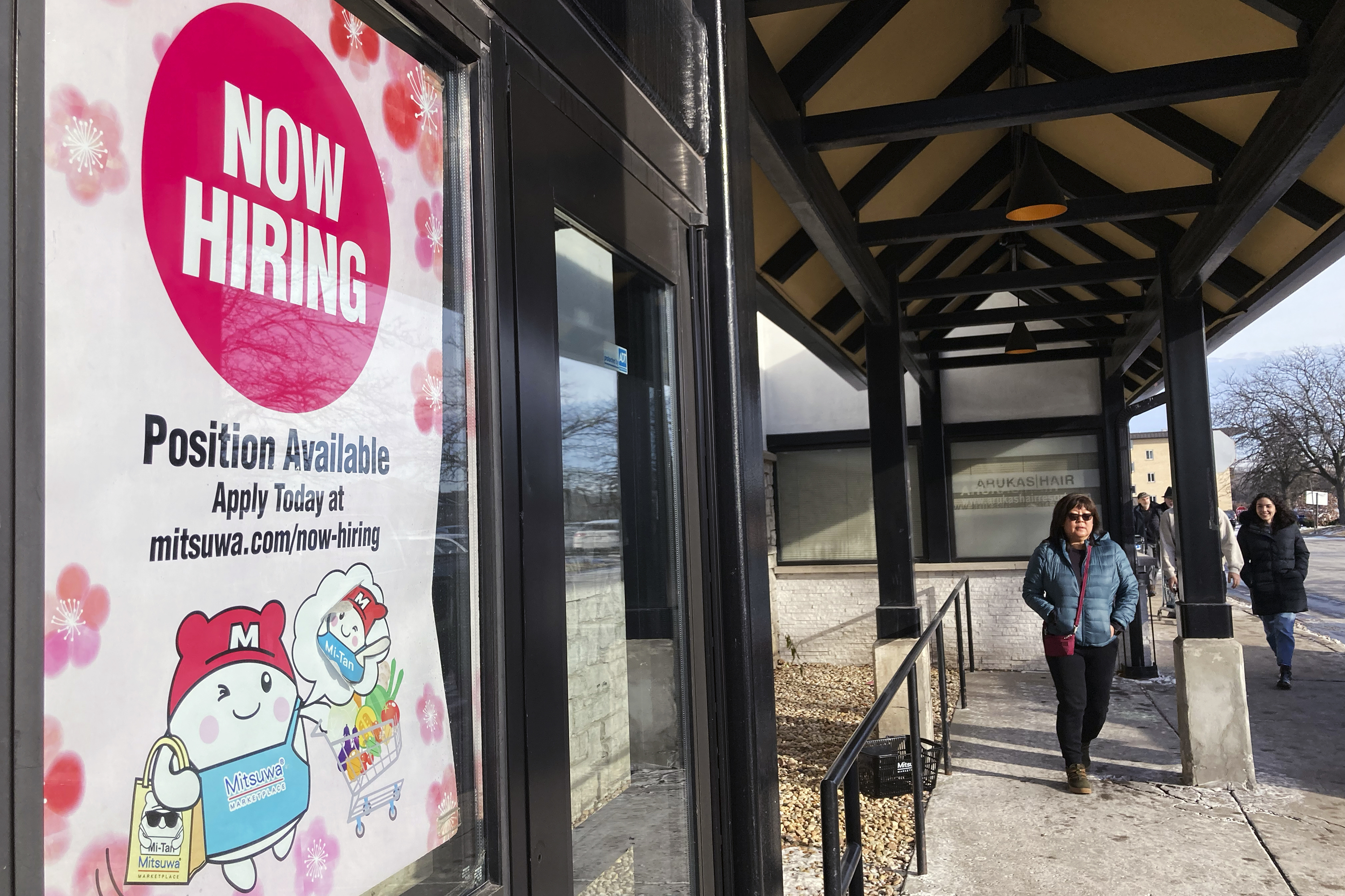 A hiring sign is displayed at a grocery store in Arlington Heights, Illinois, US