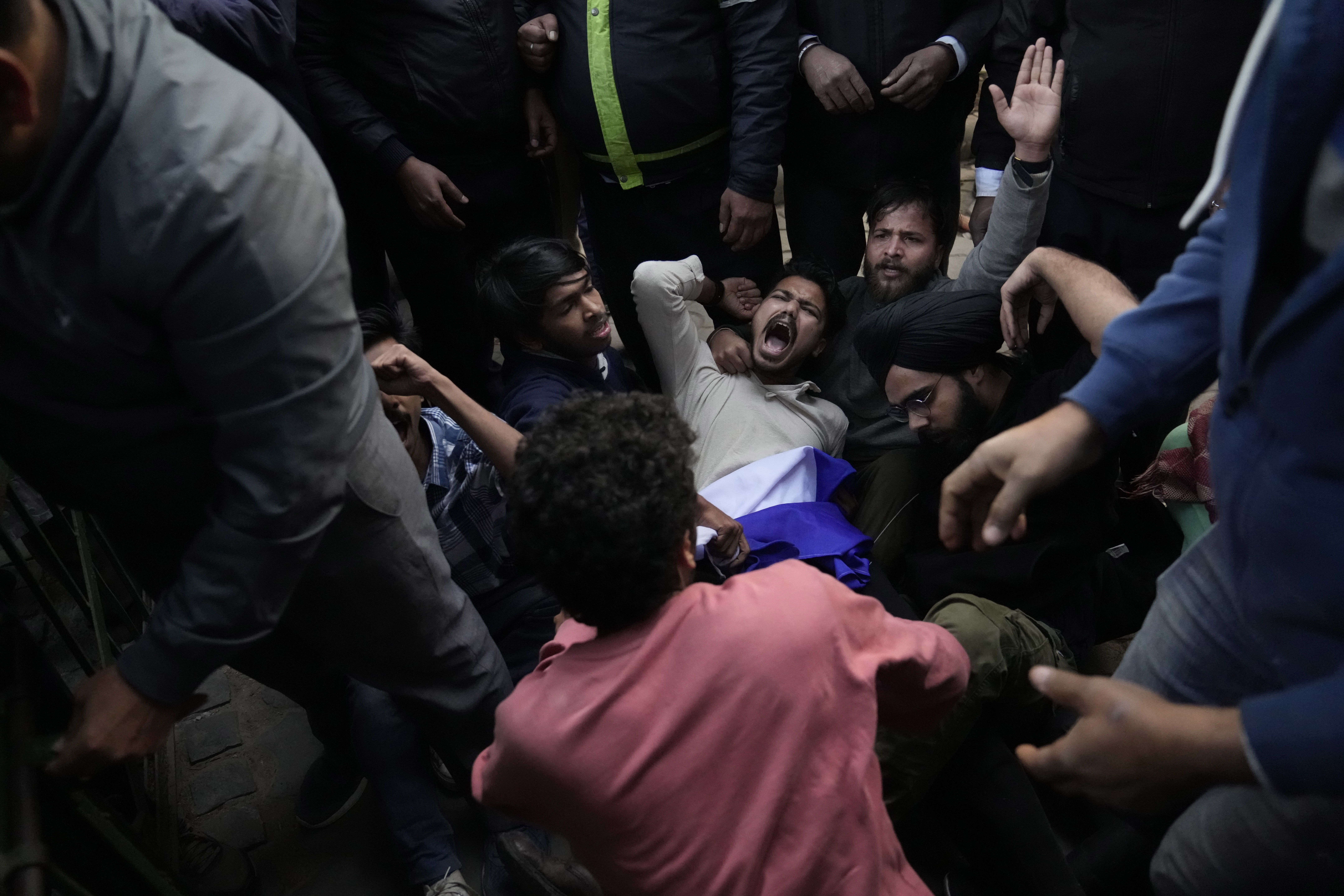 Students who wanted to screen a BBC documentary resist being escorted out.