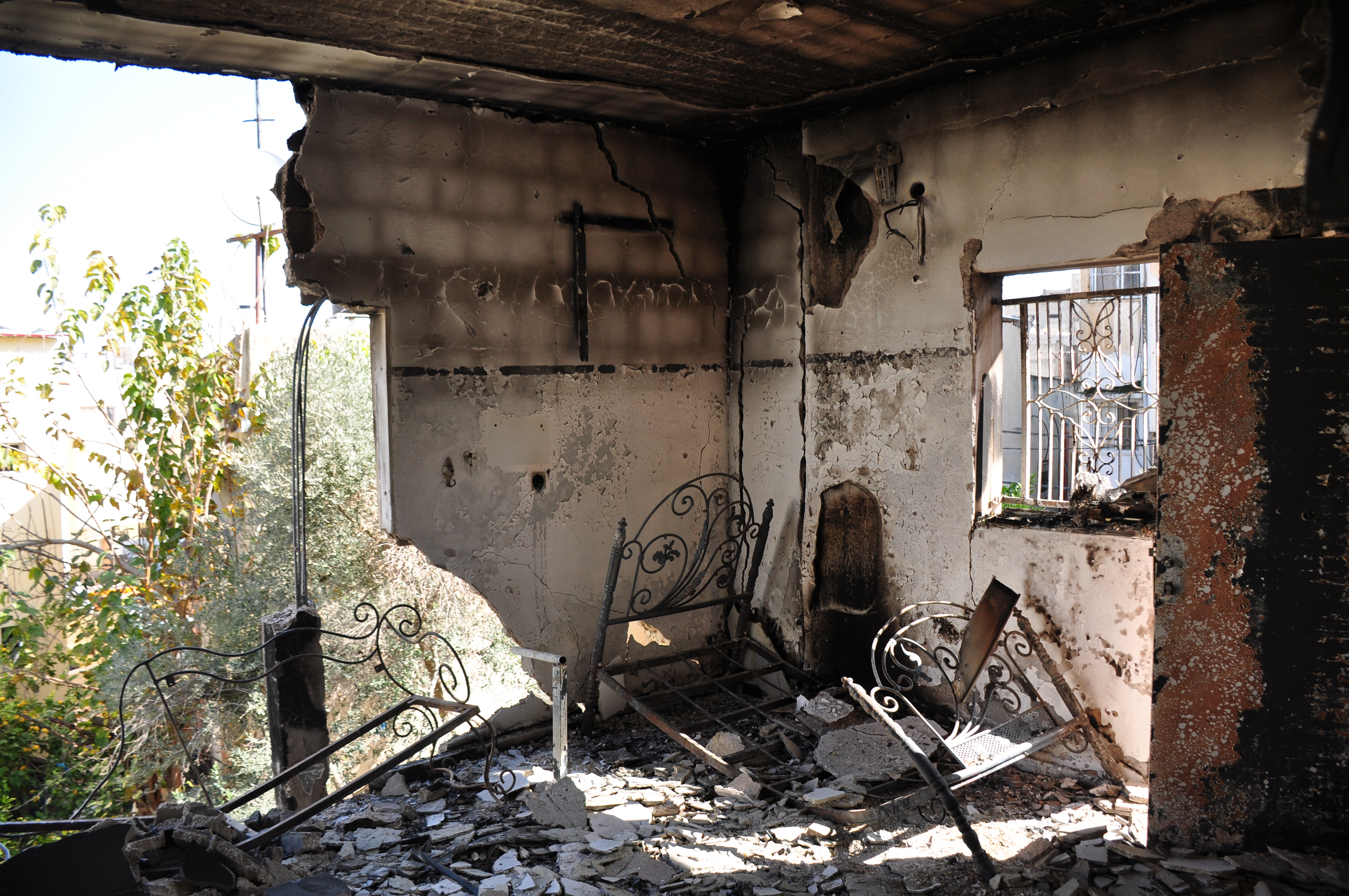 The destroyed home where three known Palestinian fighters were taking shelter when Israel attacked it with surface-to-air missiles, causing it also to set on fire.