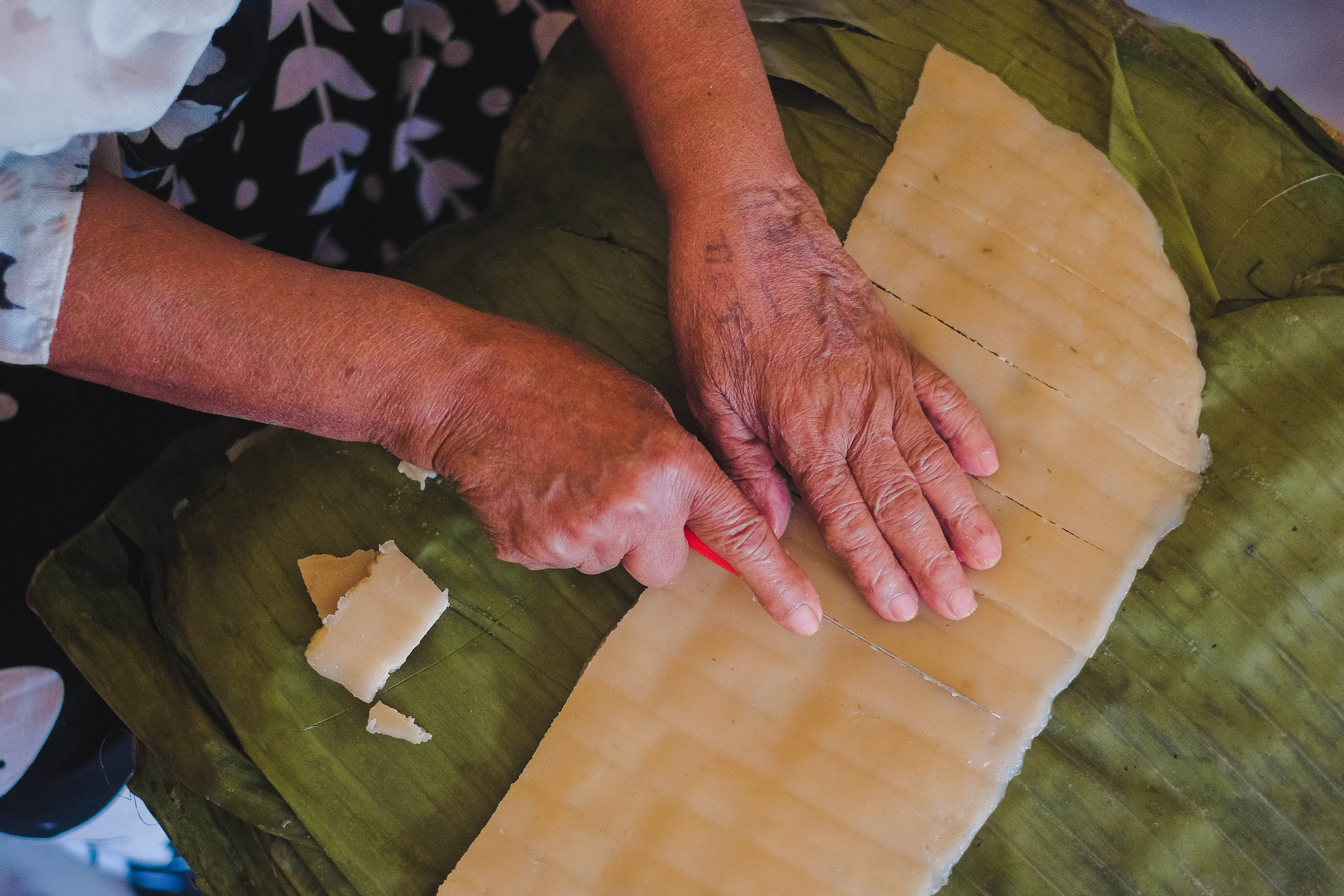 Bekelech's hands as she cuts strips of kocho for toasting