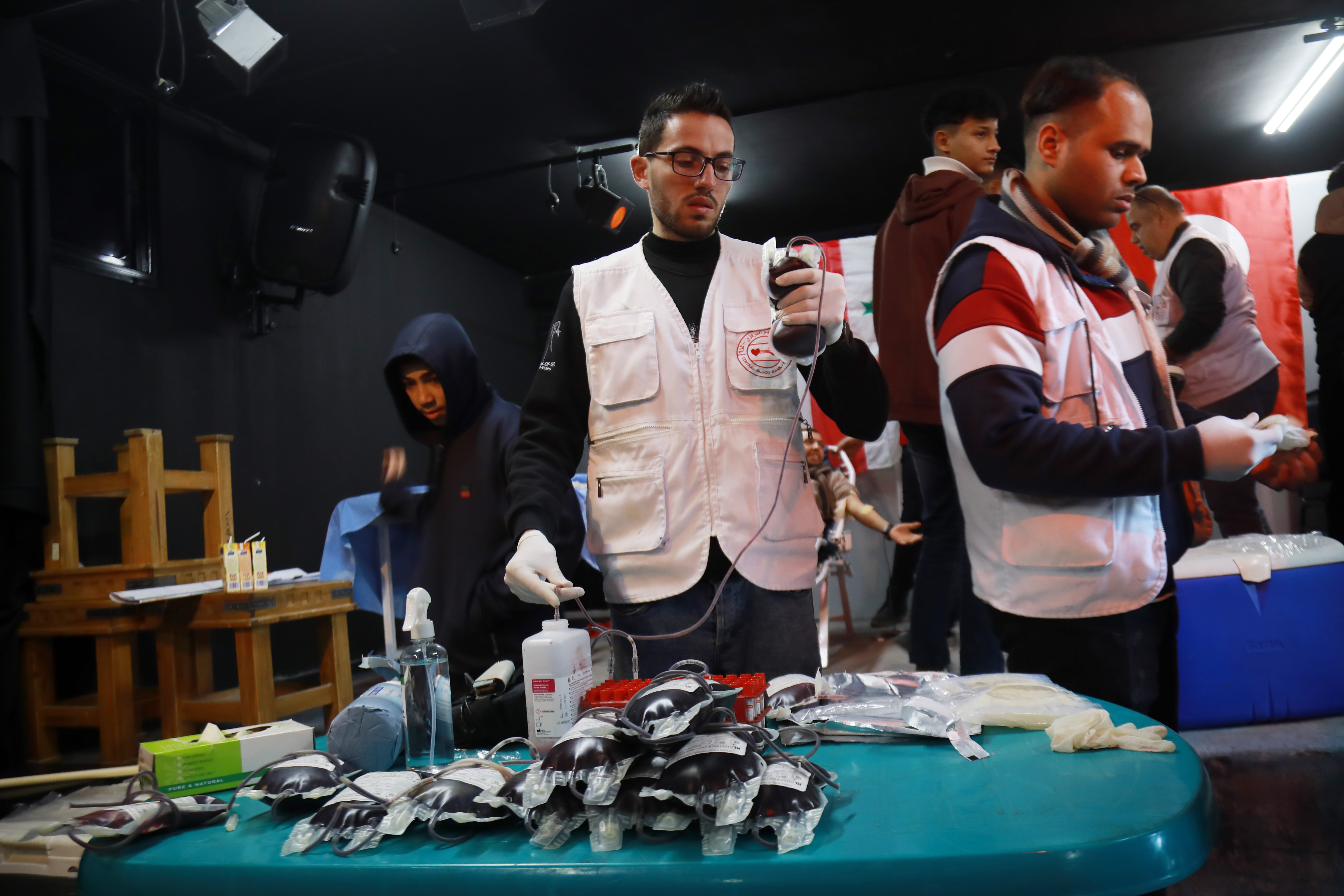 Medical workers check blood units