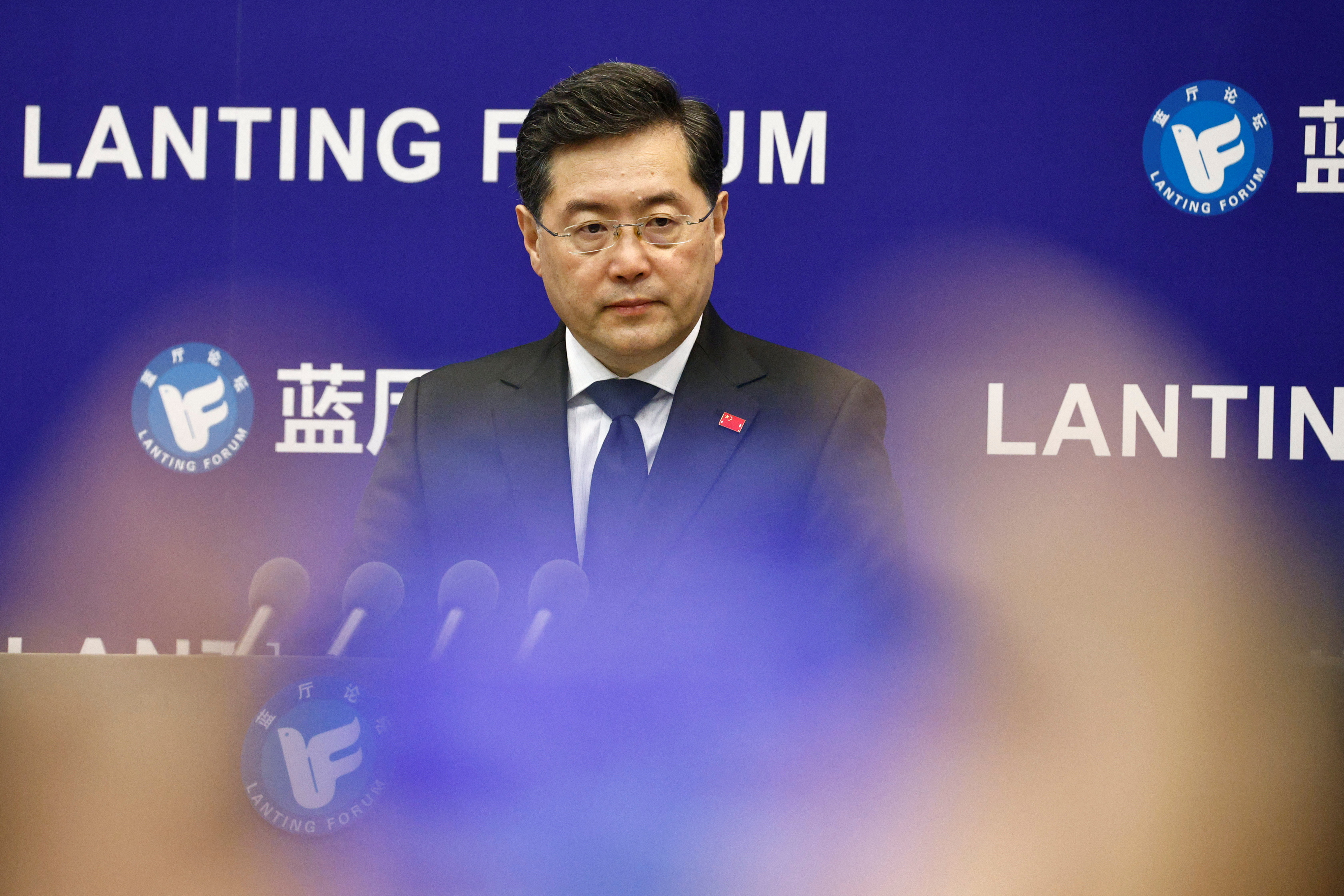 Chinese Foreign Minister Qin Gang at the Lanting Forum in Beijing. He is standing at a lectern with a blue banner behind him. The banner says Lanting Forum in English.