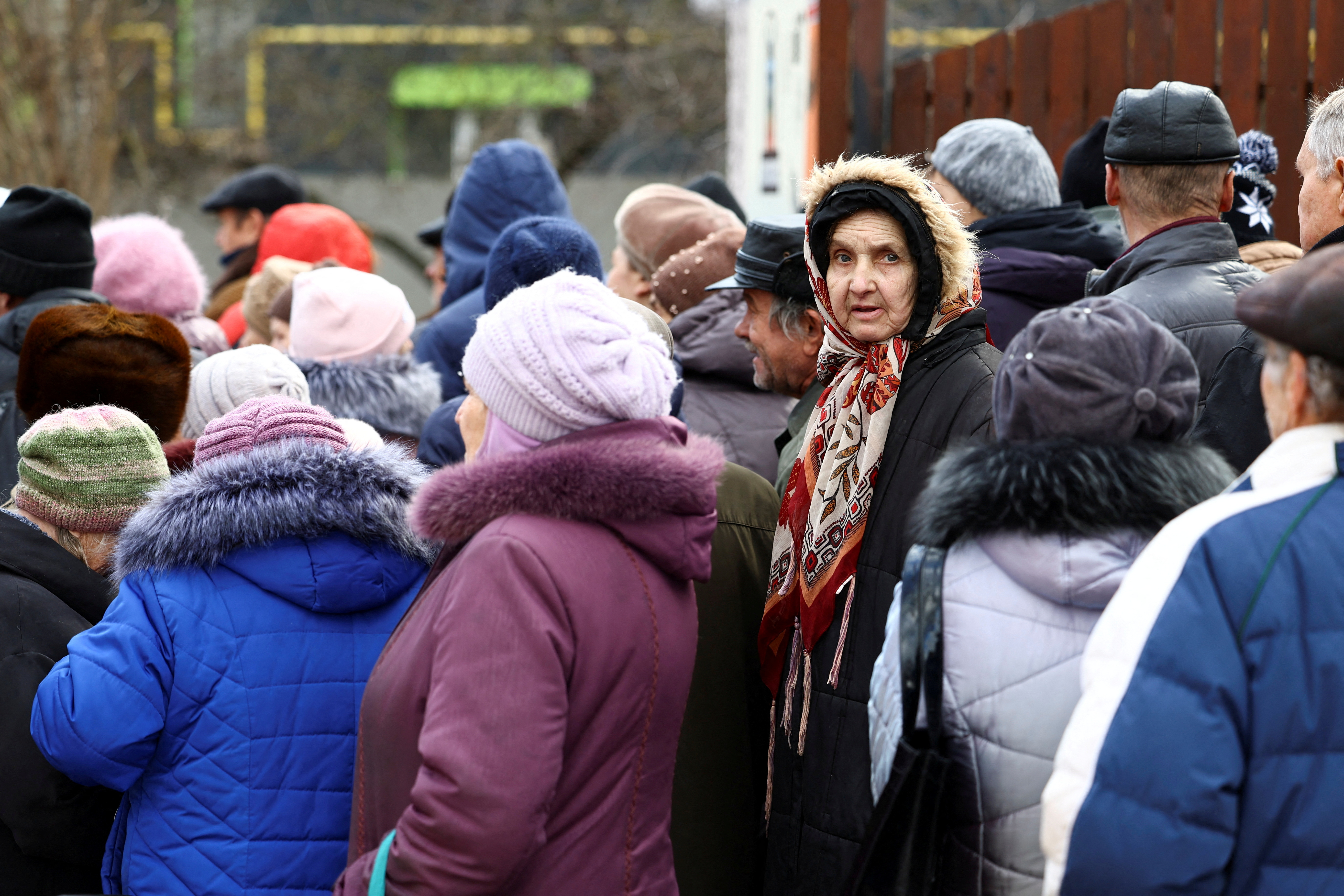 People queue for meals from World Central Kitchen food truck in Kherson, Ukraine