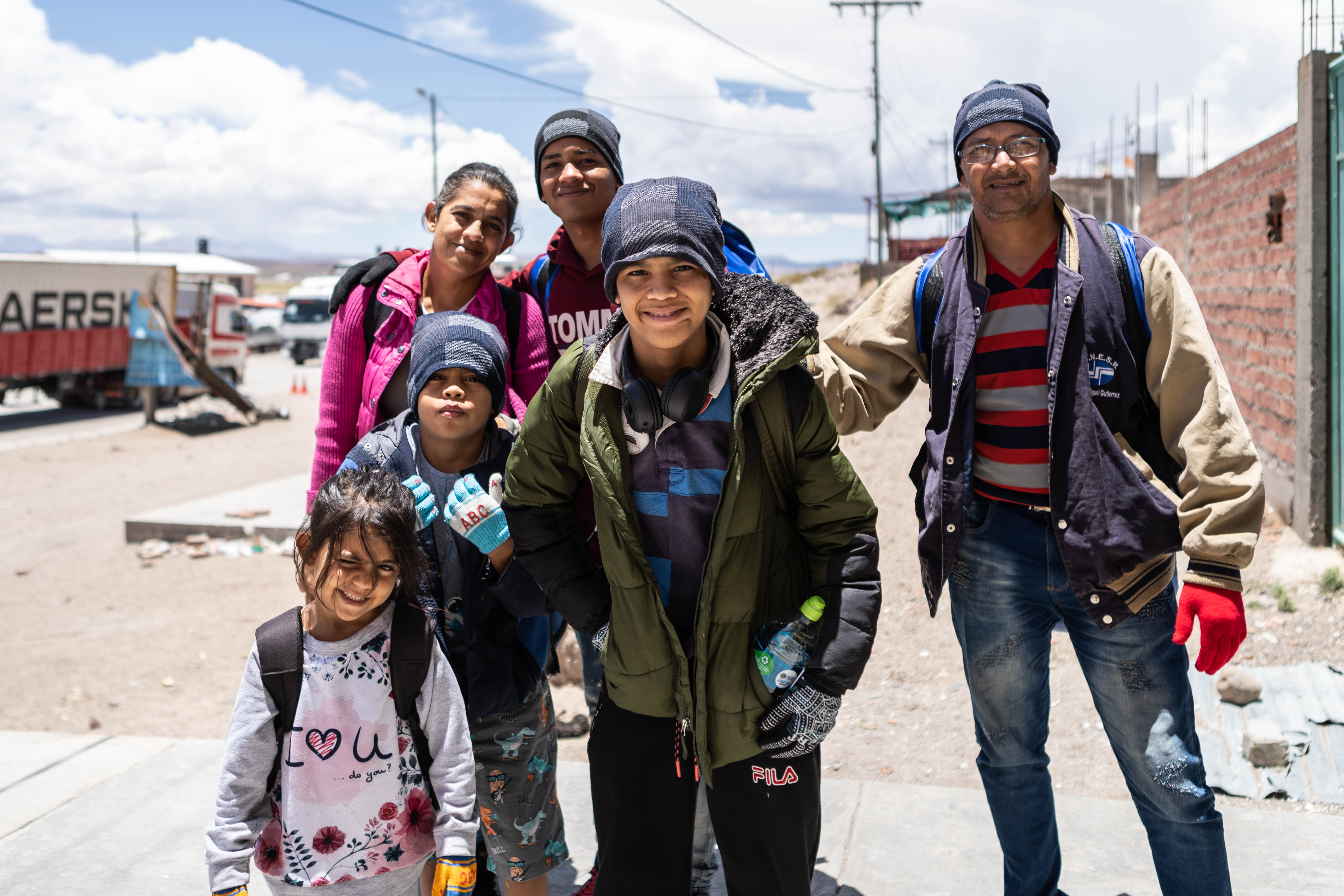 With Allyson — the smallest member of the family — standing in front, three of her siblings plus her parents pose in the desert-like roads on the Bolivian-Chilean border.