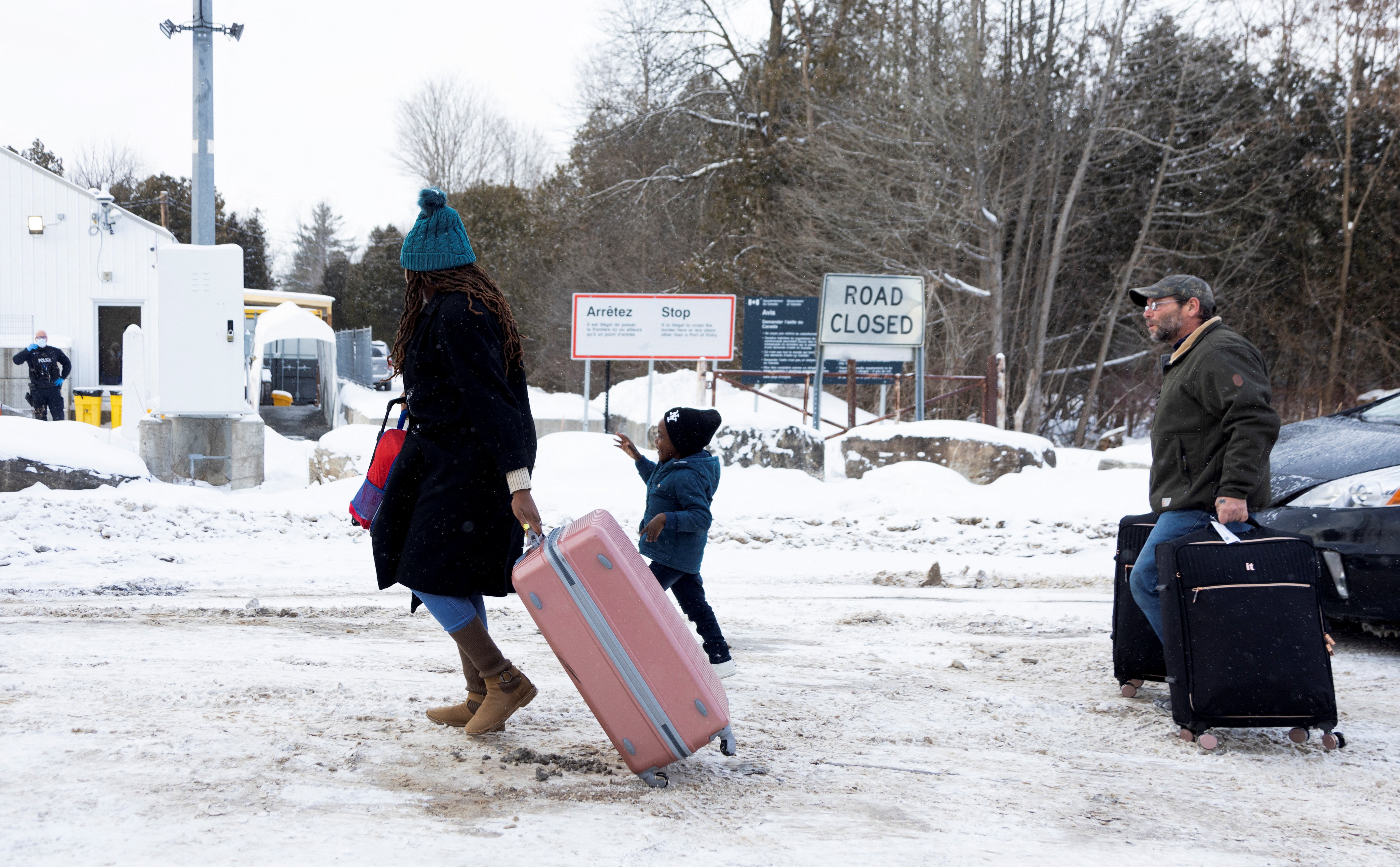 Asylum seekers arrive by taxi to cross into Canada from the US border on Roxham Road between New York state and Quebec
