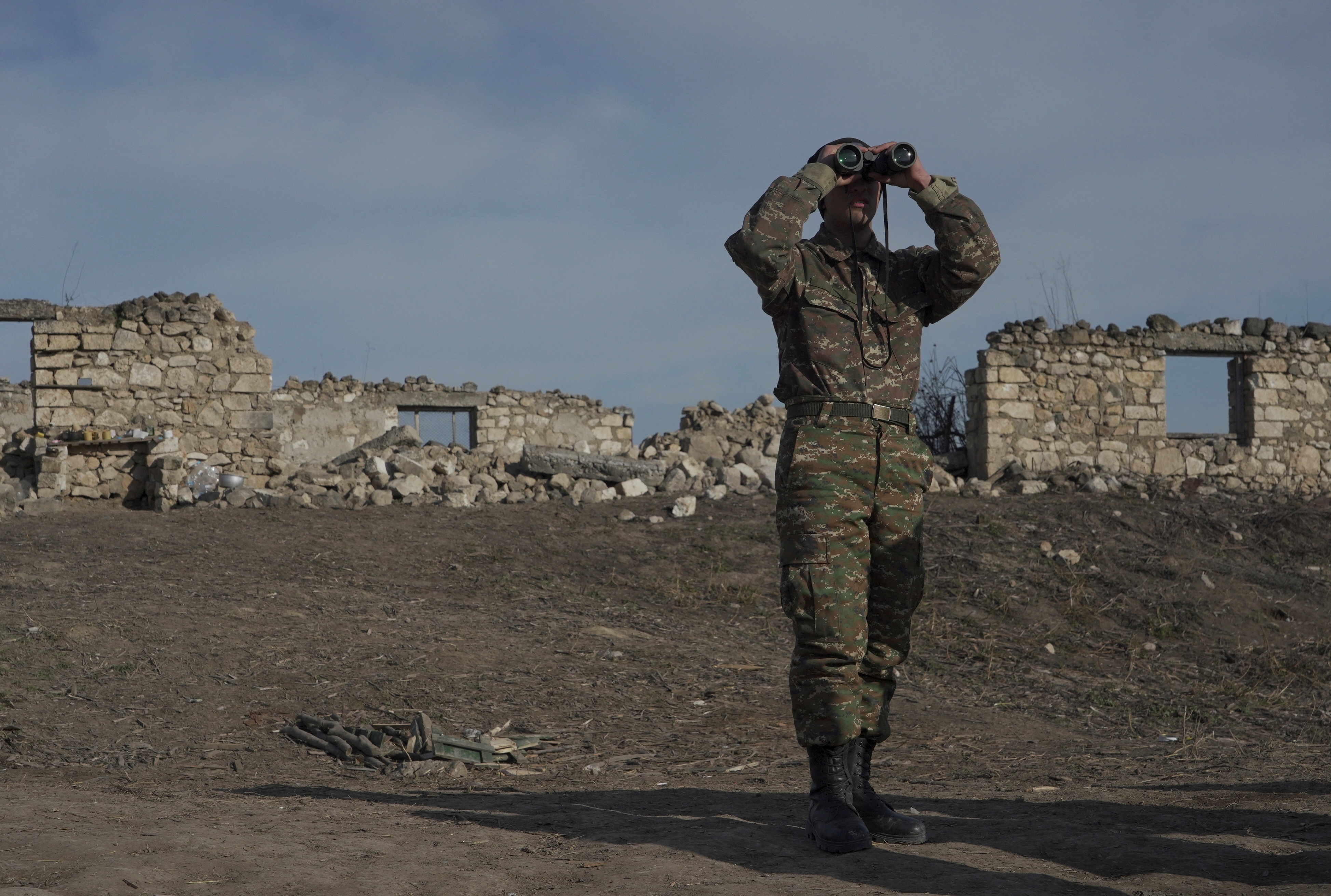 An ethnic Armenian soldier looks through binoculars
