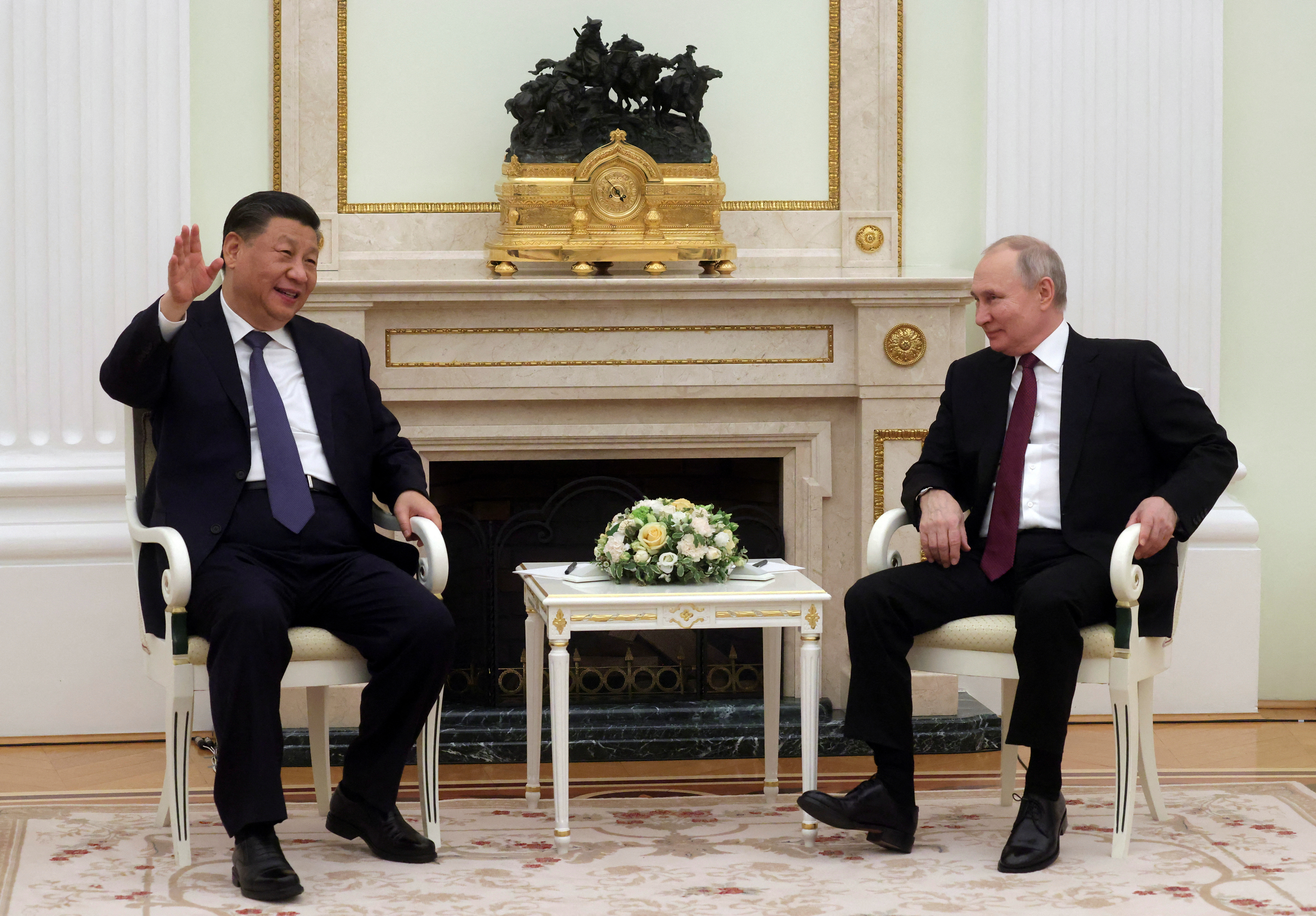 Russian President Vladimir Putin and Chinese President Xi Jinping attend a meeting at the Kremlin in Moscow, Russia, March 20, 2023. The leaders are looking relaxed, smiling even, as they sit talking.