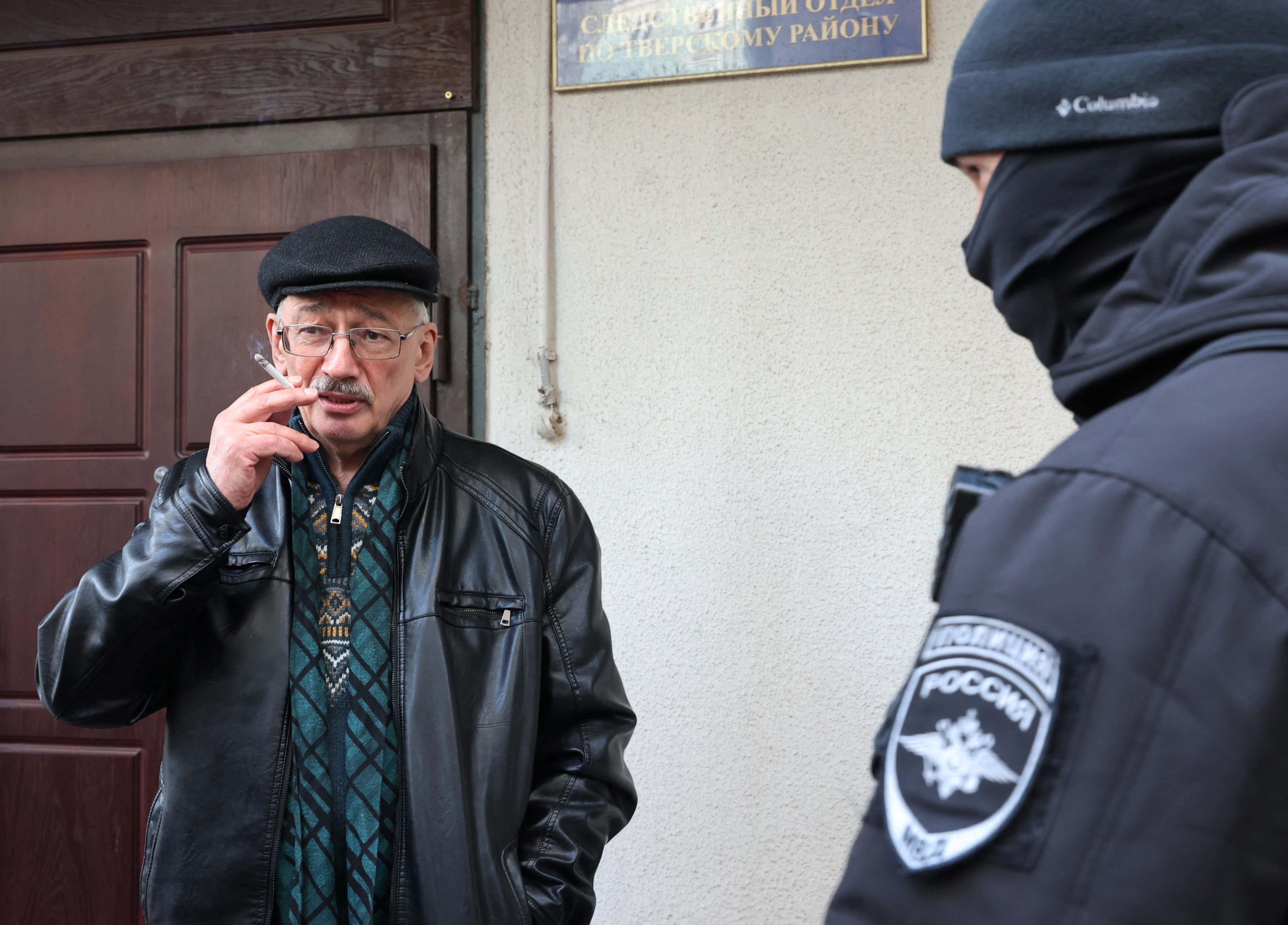 Oleg Orlov, chairman of Russian human rights centre Memorial, smokes while being delivered to Russian Investigative Committee in Moscow, Russia March 21, 2023. REUTERS/Yulia Morozova