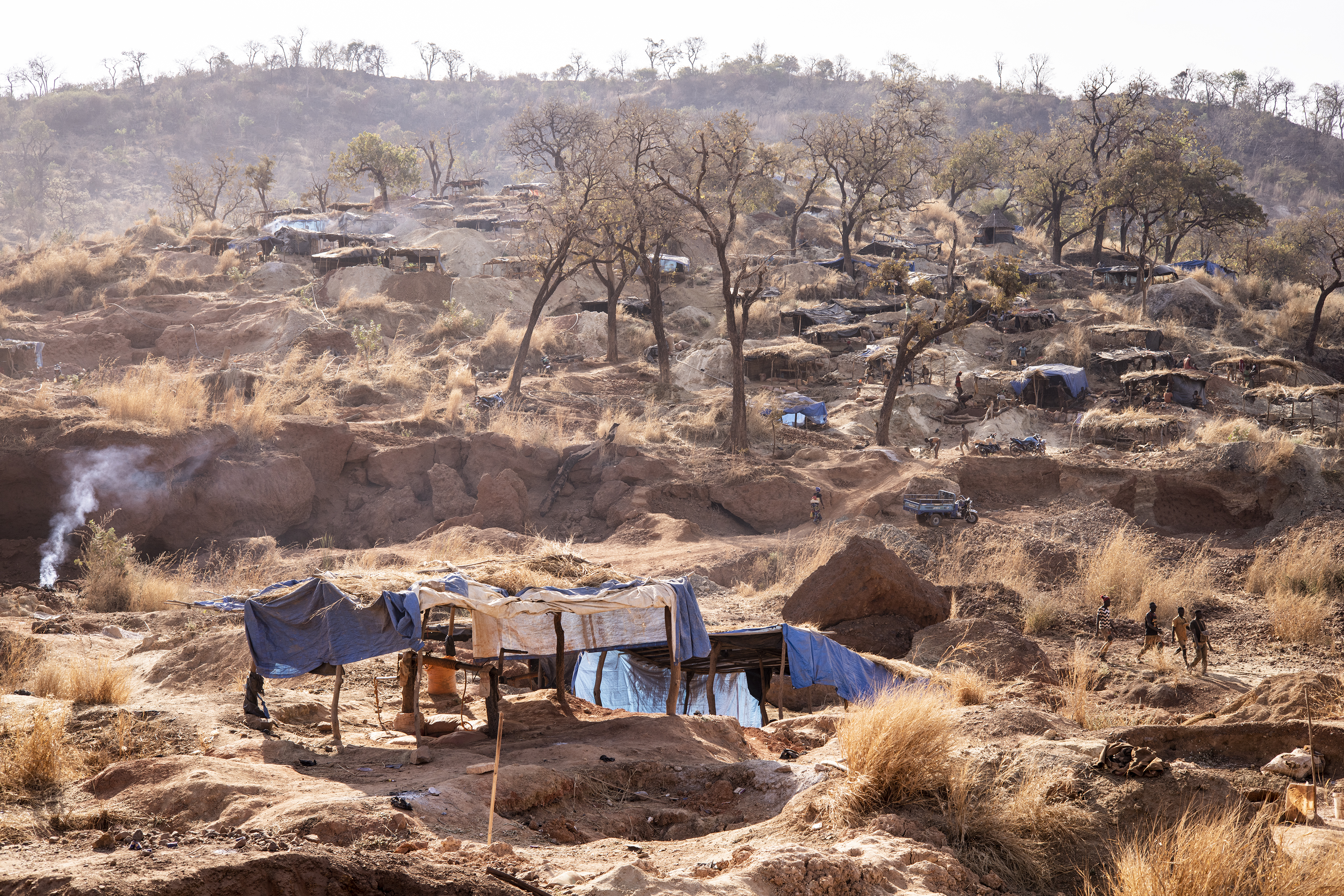 Artisanal gold miners walk through the Karakaene gold mine