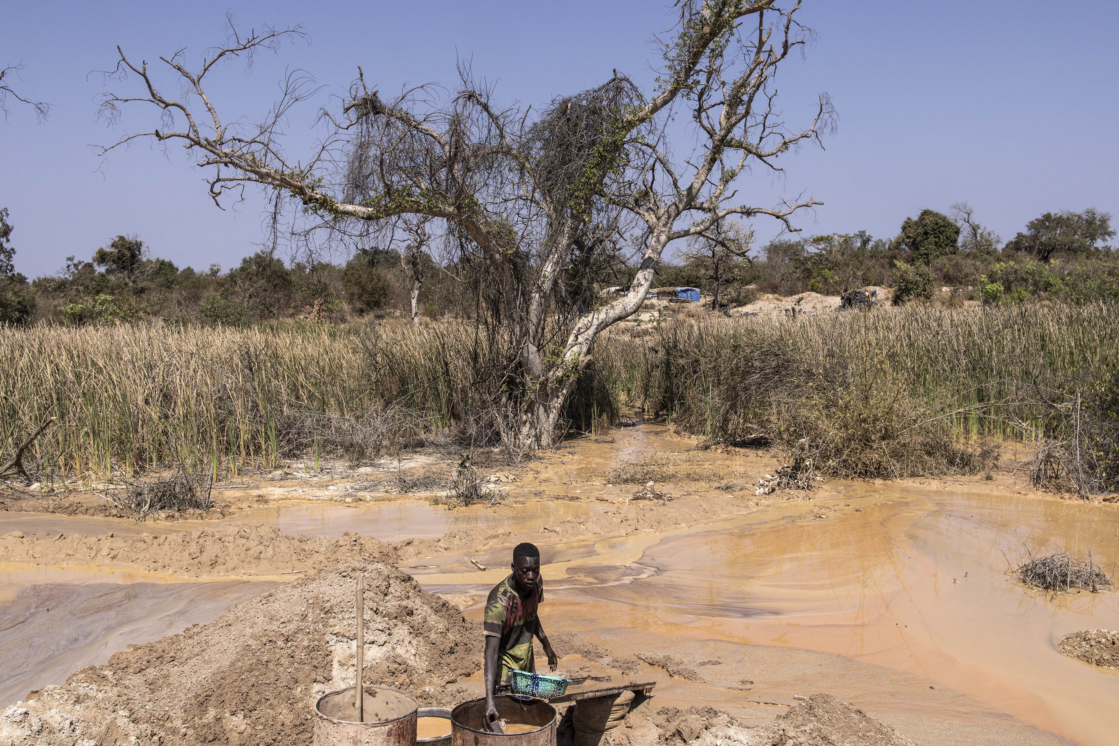 An artisanal gold miner pans for gold at the Bantakokouta gold mine