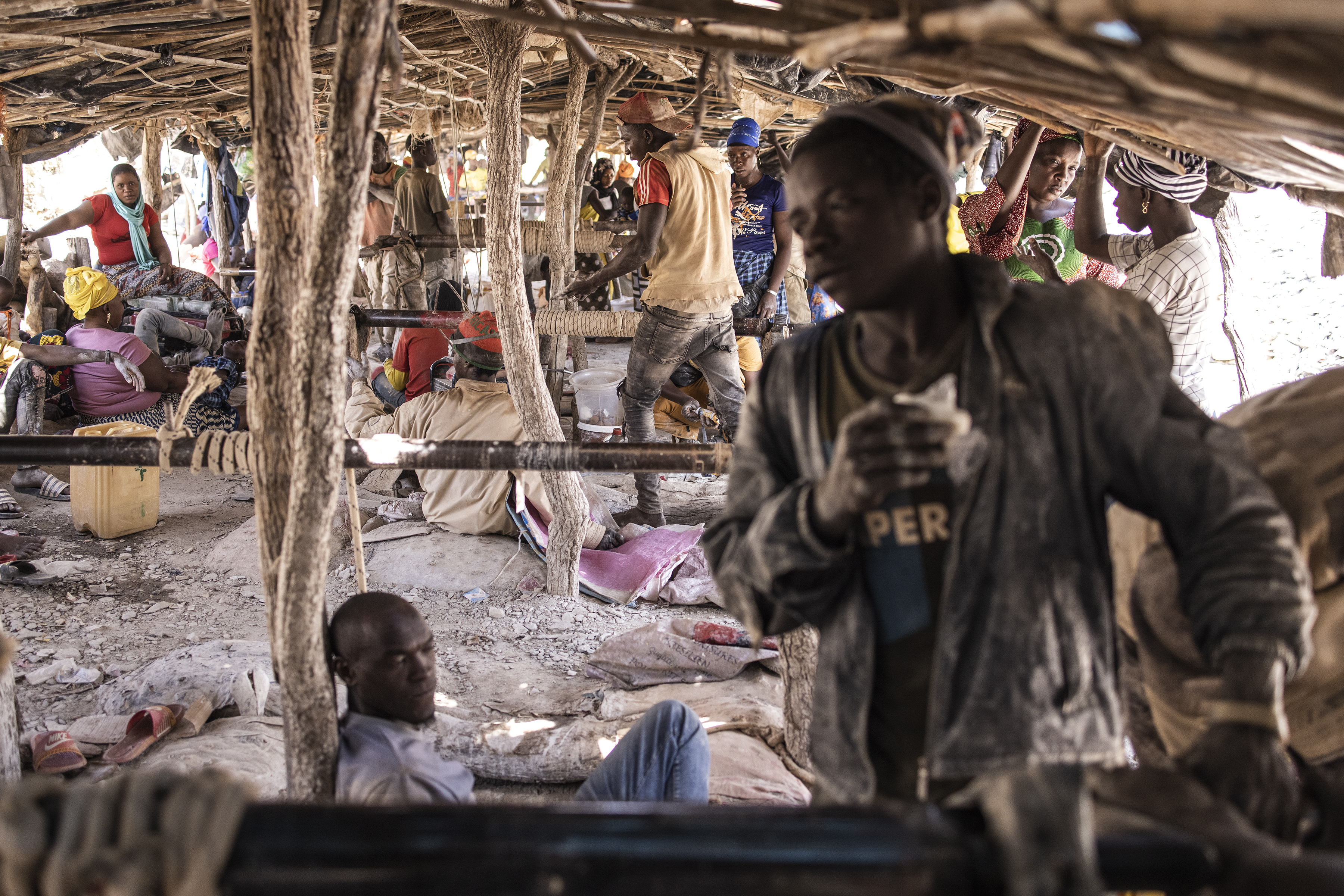 Artisanal gold miners cross The Gambia river at the Bantakokouta gold mine