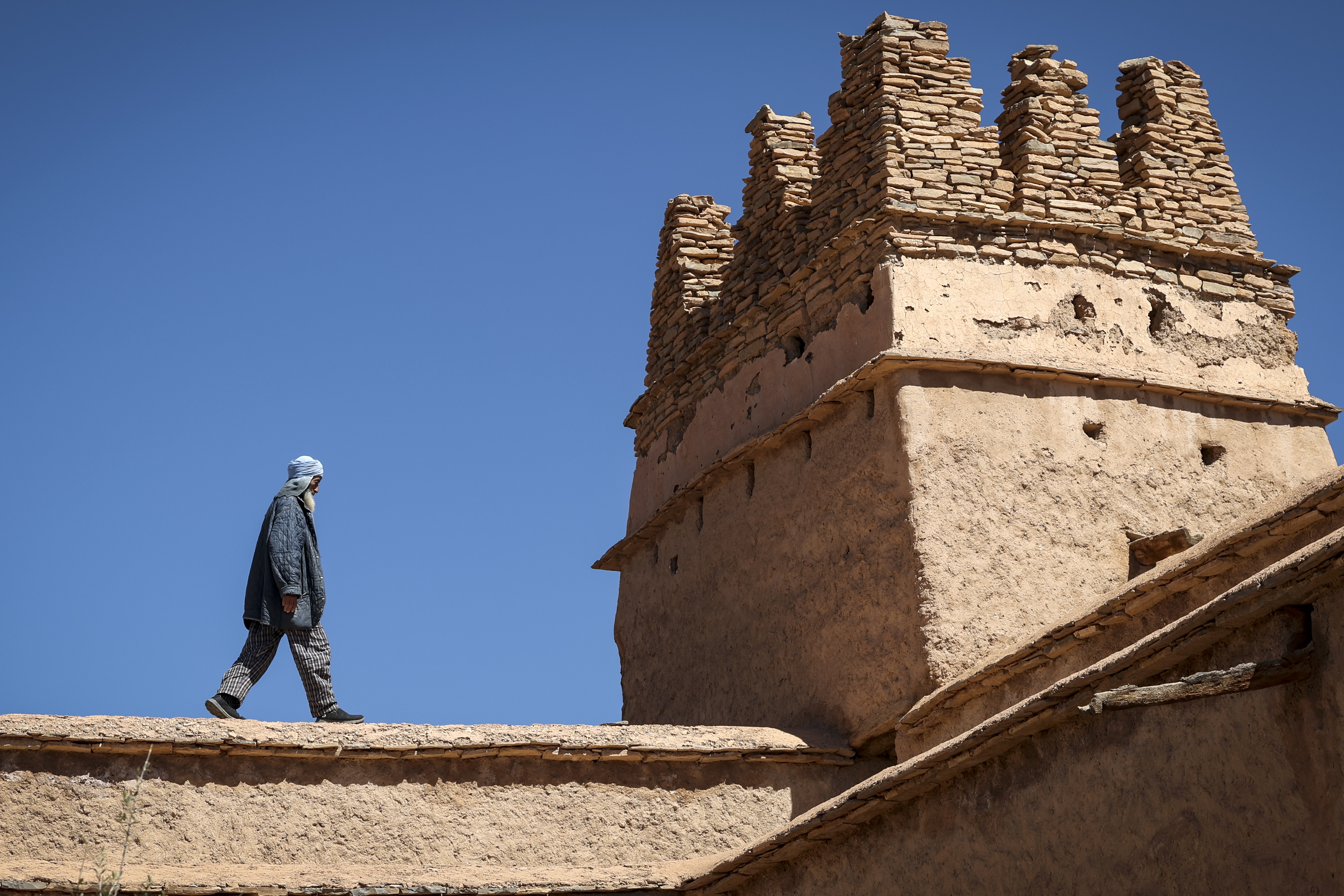 Guardian Lahcen Boutirane walks at the ancient collective granary of Ait Kine village in Morocco's region of Tata