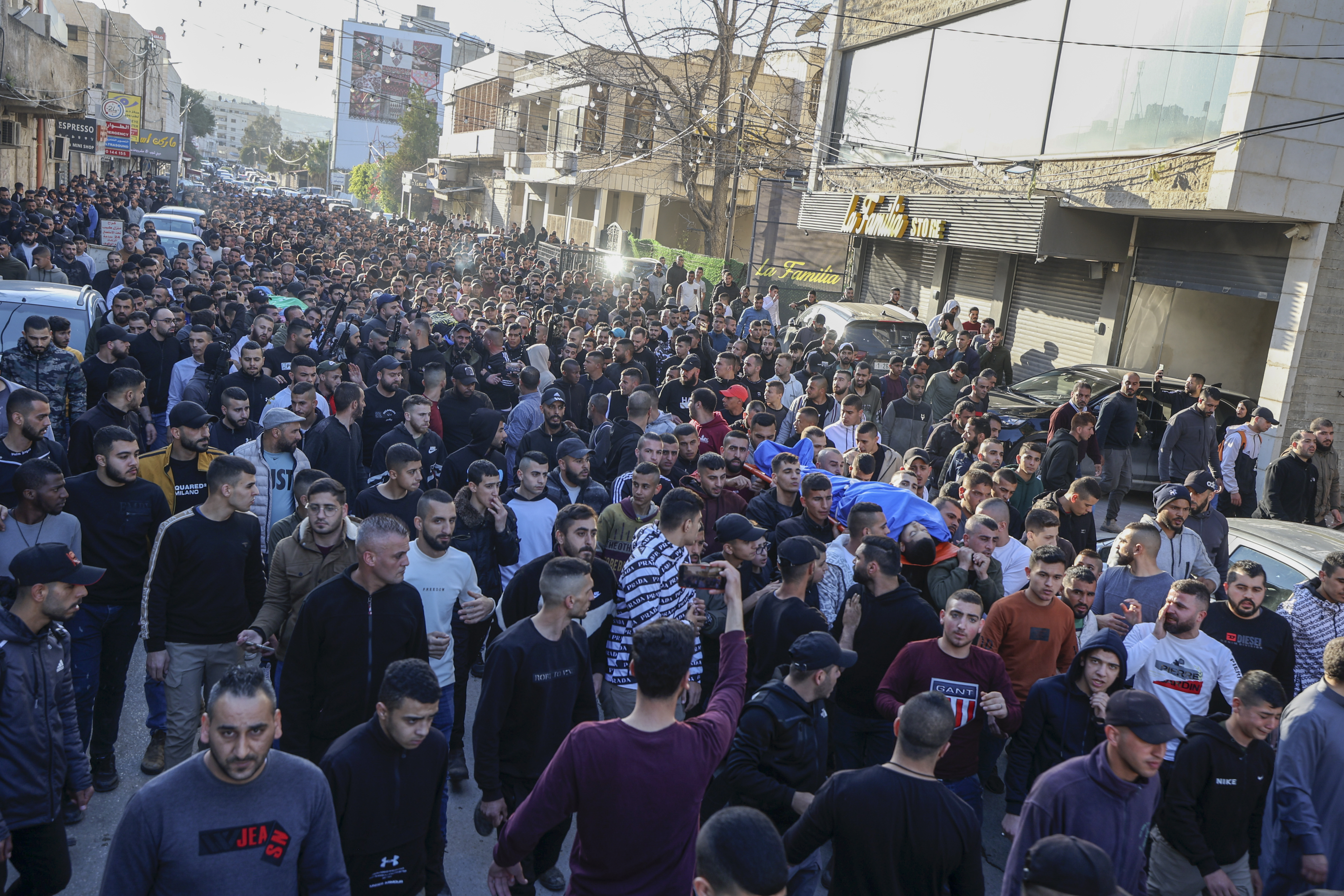 Mourners carry the bodies of Palestinians killed in an Israeli raid