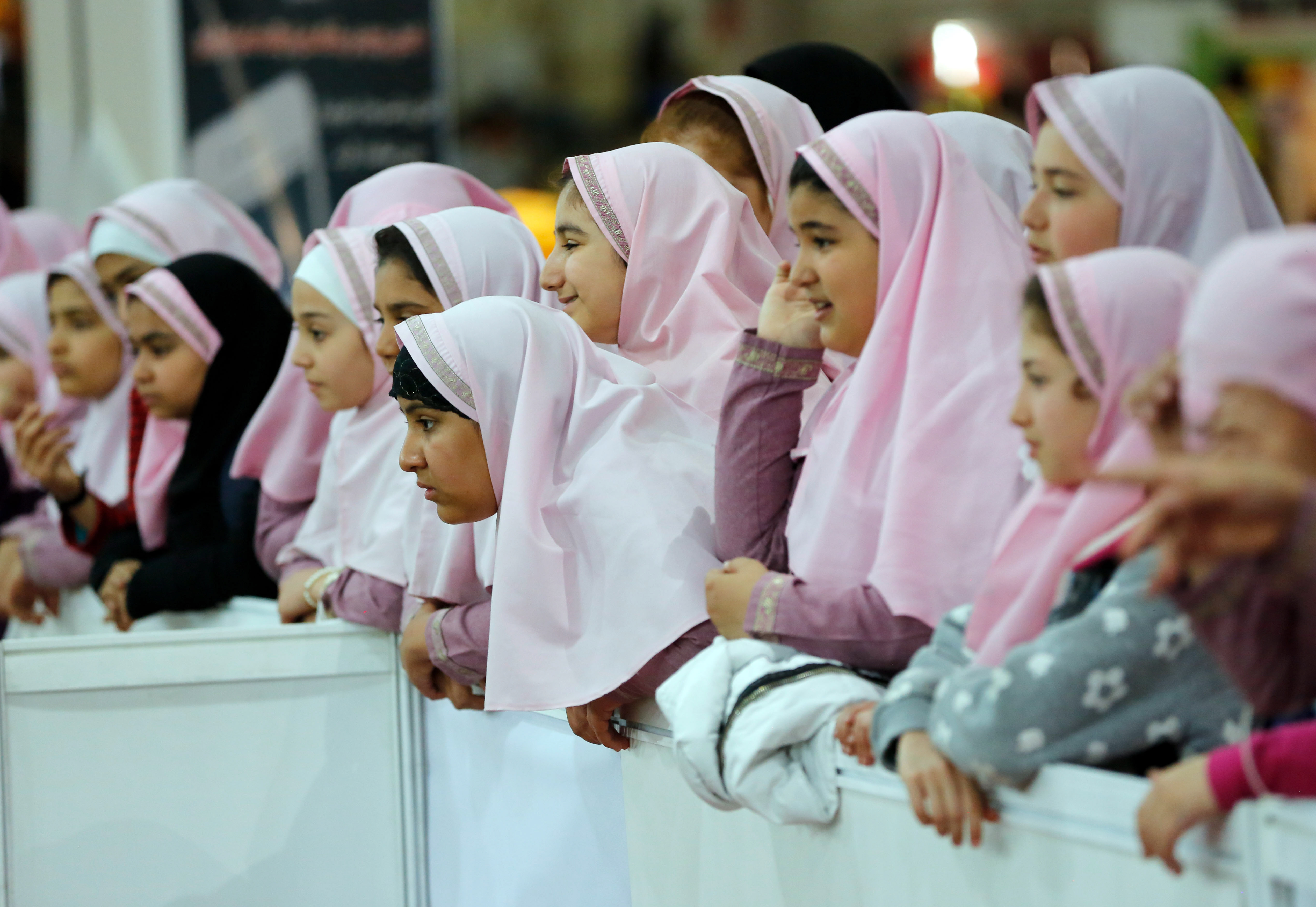 Iranian schoolgirls watch a Robot soccer match in Iran.