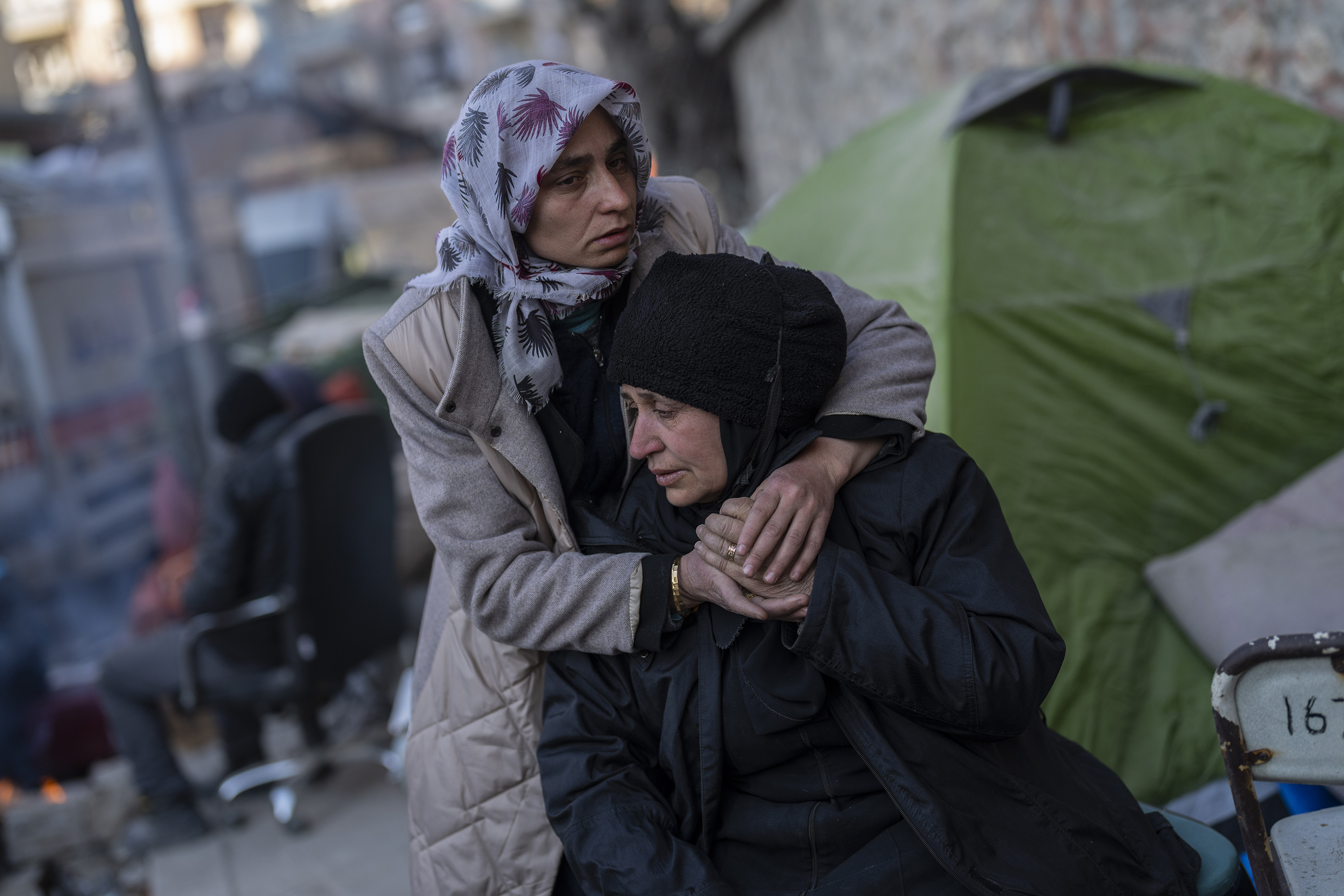 A family mourns moments after a body of a relative was pulled out of a building destroyed during the earthquake in Antakya
